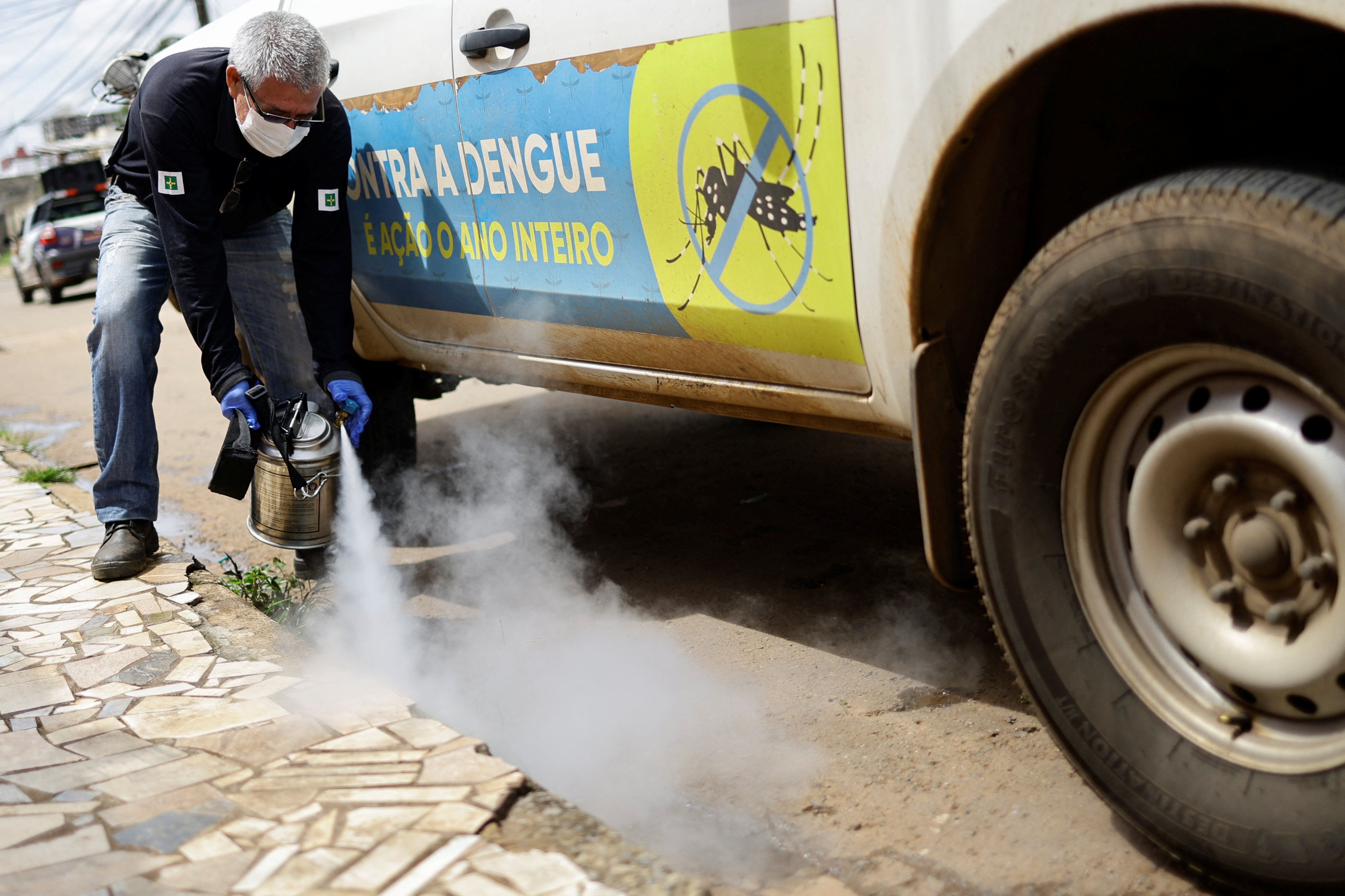 A health worker sprays insecticide to kill the Aedes aegypti mosquito to help mitigate a dengue outbreak in the Ceilandia neighborhood of Brasilia, Brazil February 7, 2024. 