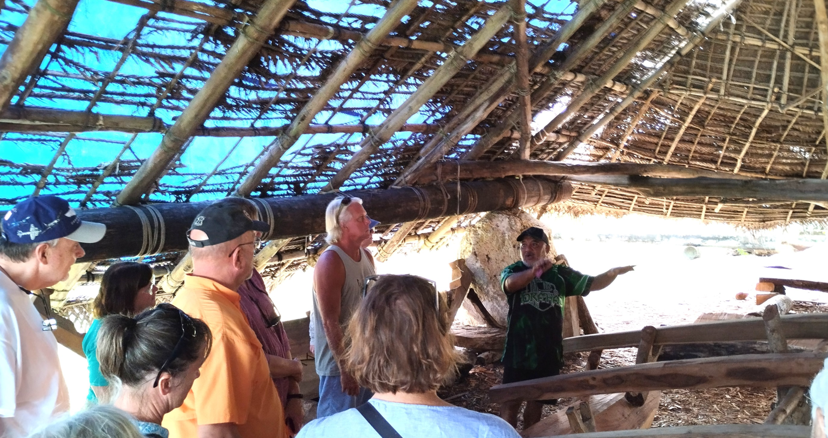 Alvin Takai, former helper on the Seafaring Traditions Program, shares his knowledge of traditional canoe making with curious onlookers.