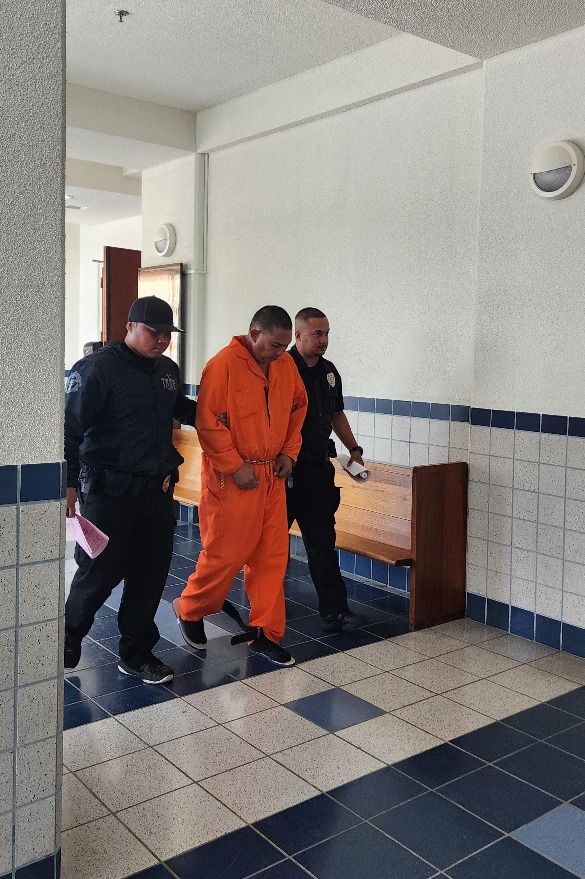 Christopher San Nicolas King, center, is escorted by Corrections officers after a bail hearing in Superior Court on Wednesday afternoon.