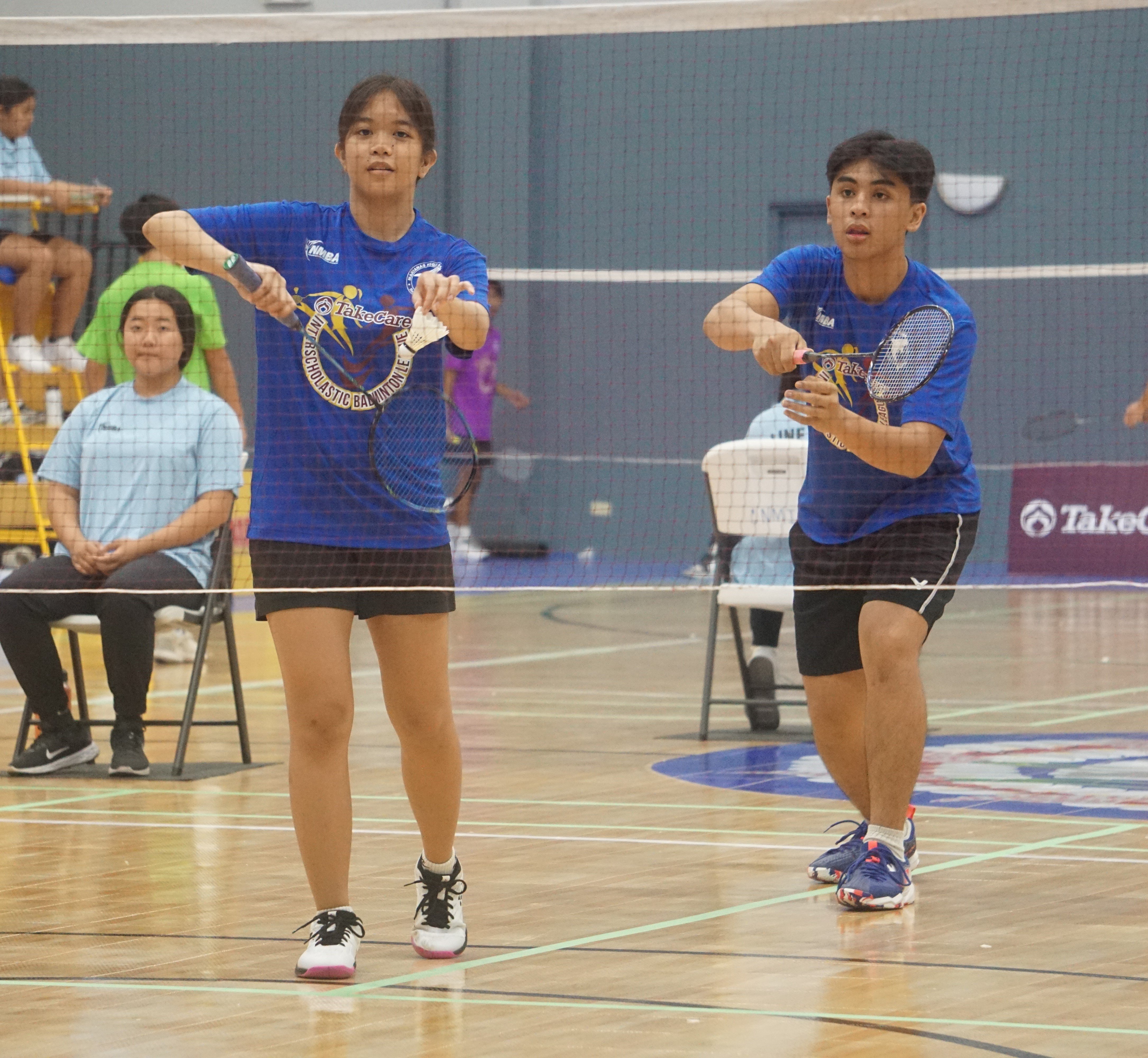 Team MHS gets ready to serve during a mixed doubles event in the co-ed high school division of the NMBF-PSS Interscholastic Badminton League SY23-24 at the Ada gym on Saturday.