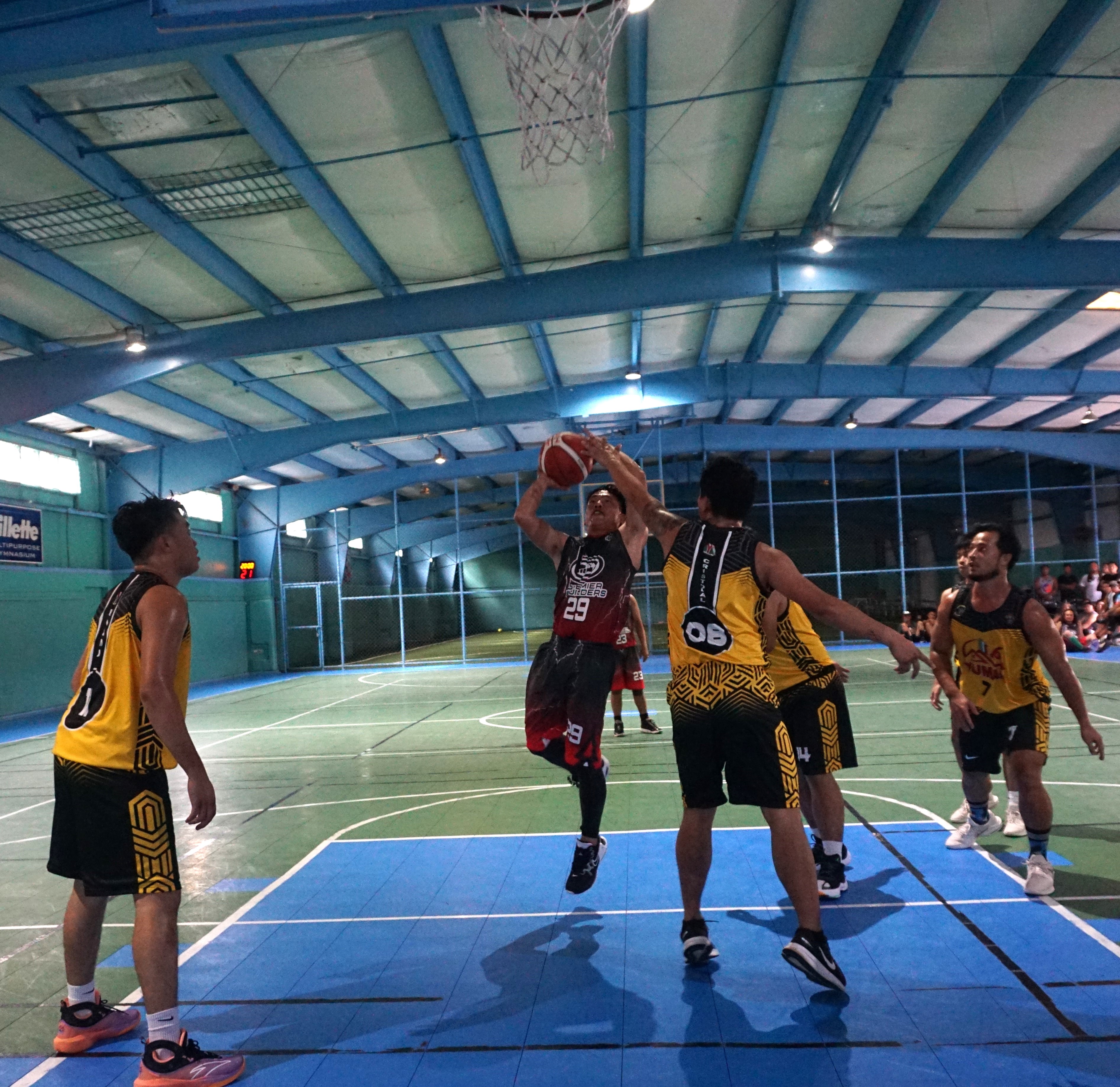 Premier Builders' Arwin Reyes goes up for the layup against four defenders during the opening game of the Legends Sports Association Invitational Basketball League Season 2 at the TSL Sports Complex on Sunday.