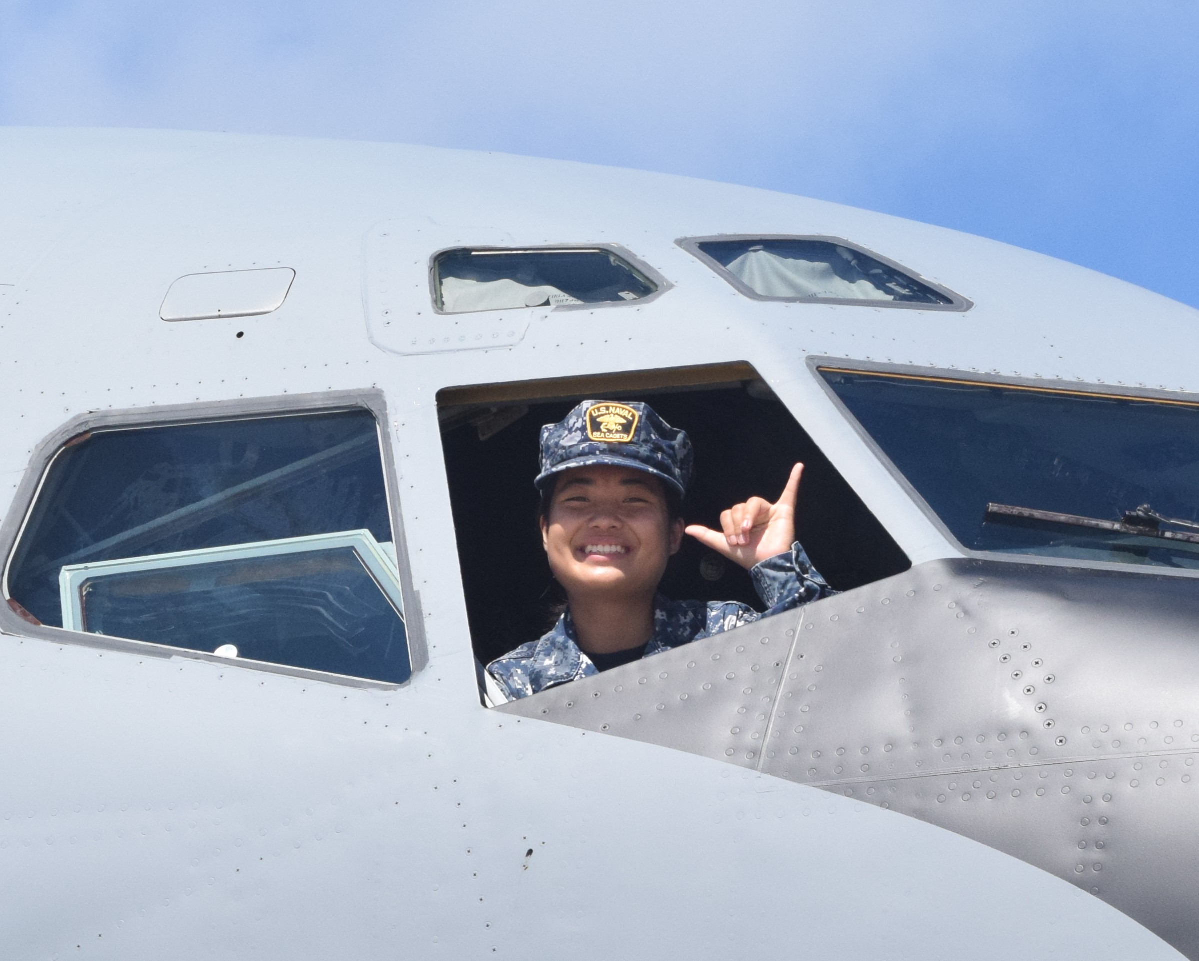 Marianas High School Grade 11 student Jessica Ma throws the shaka from the cockpit of KC-135.
