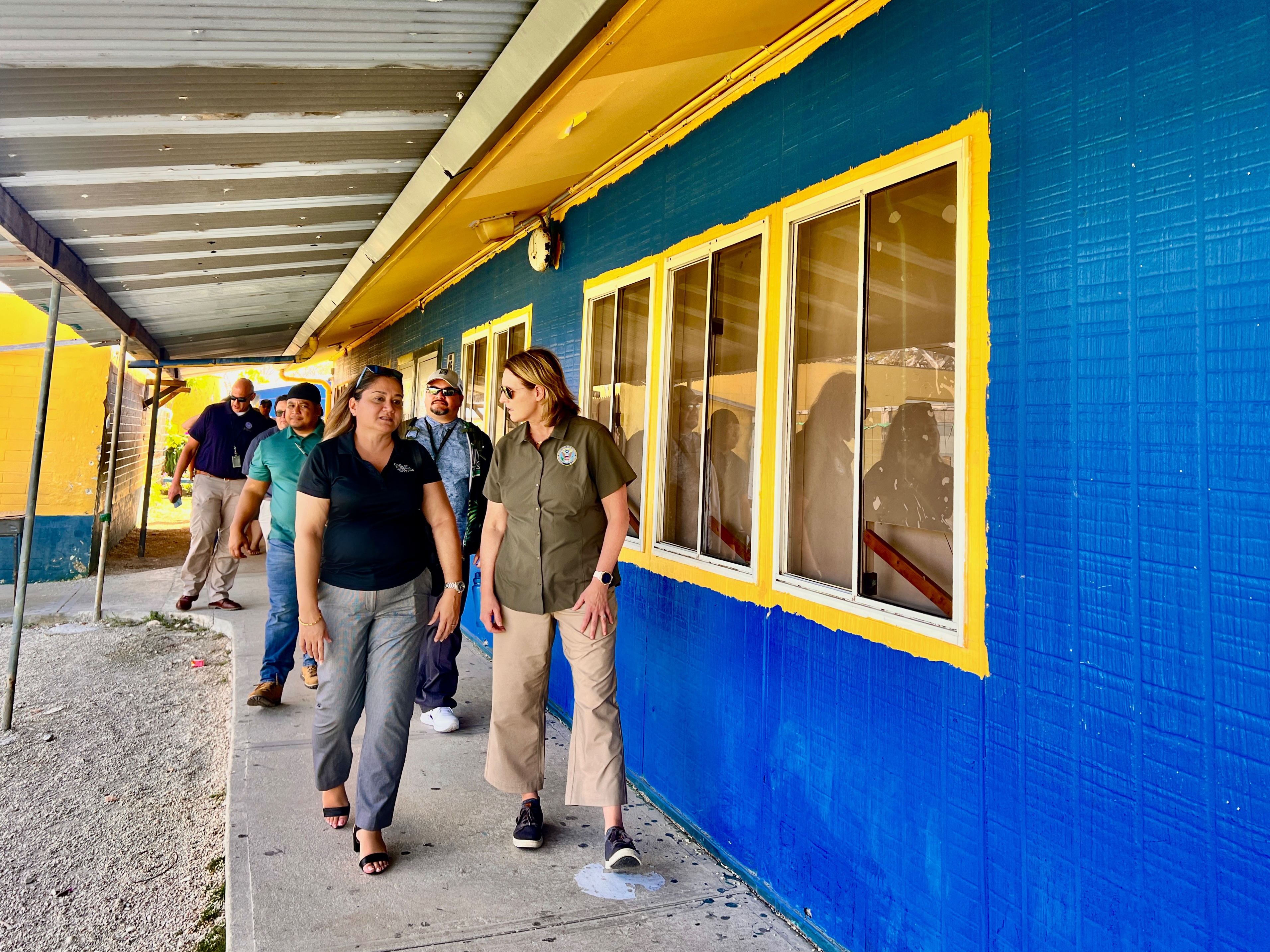 FEMA Administrator Deanne Criswell, right, Acting Commissioner of Education Donna M. Flores, left, and other PSS and FEMA officials tour Hopwood Middle School on Monday.