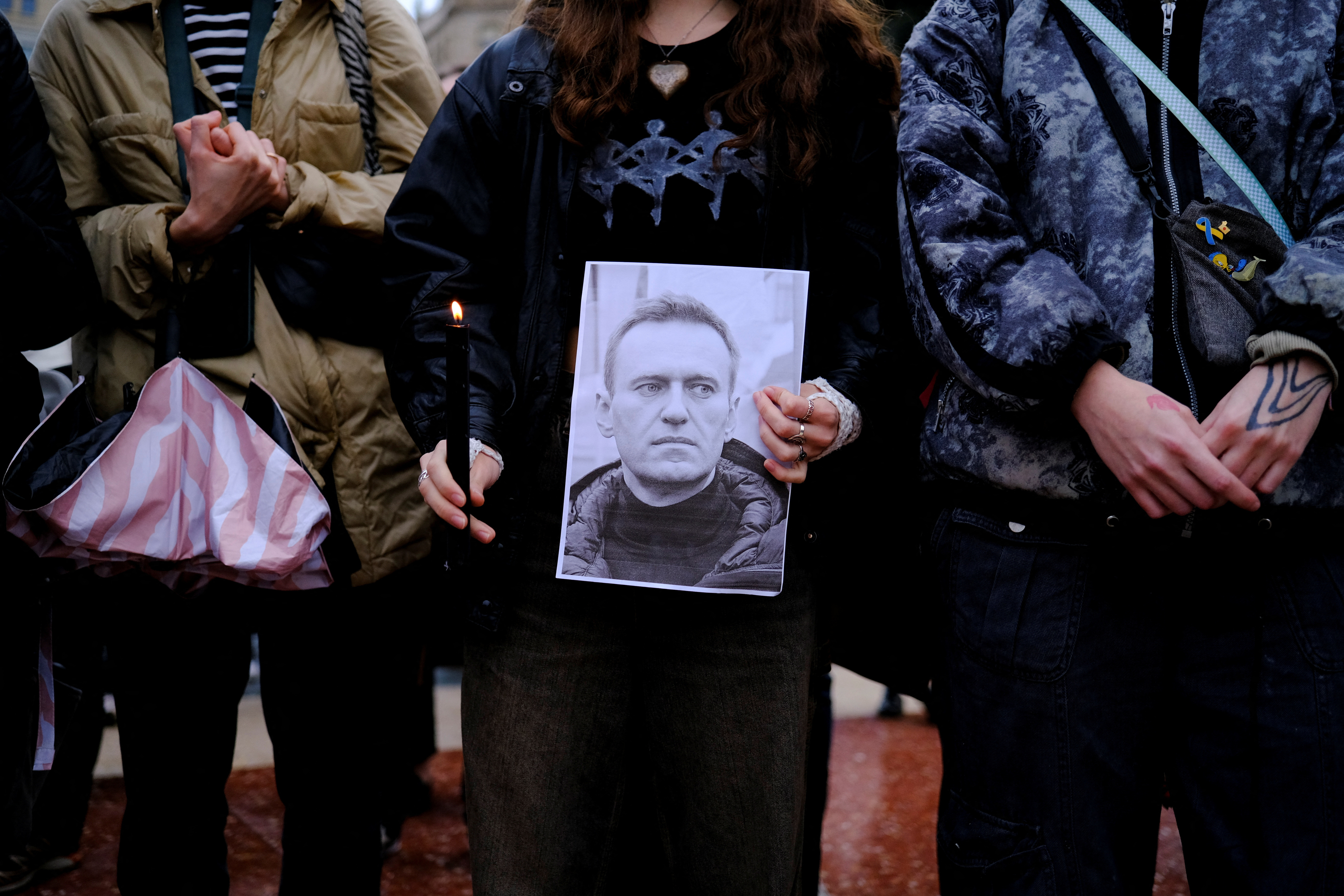 A person holds a picture of Russian opposition leader Alexei Navalny as people gather during a protest at Catalunya Square, Barcelona, Spain, February 16, 2024. 