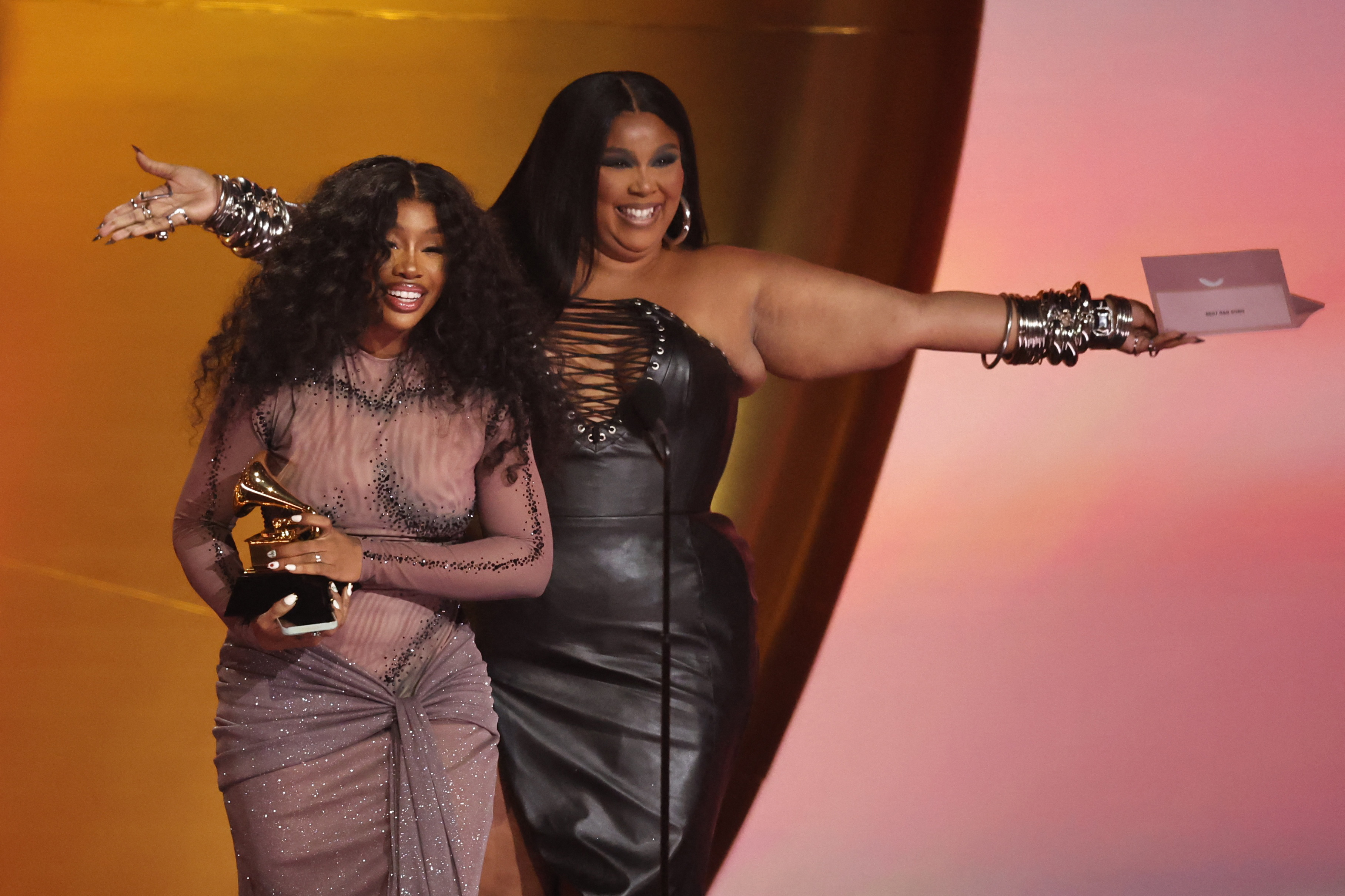 SZA accepts the award for Best R&B Song for Snooze from presenter Lizzo during the 66th Annual Grammy Awards in Los Angeles, California, Feb.  4, 2024.