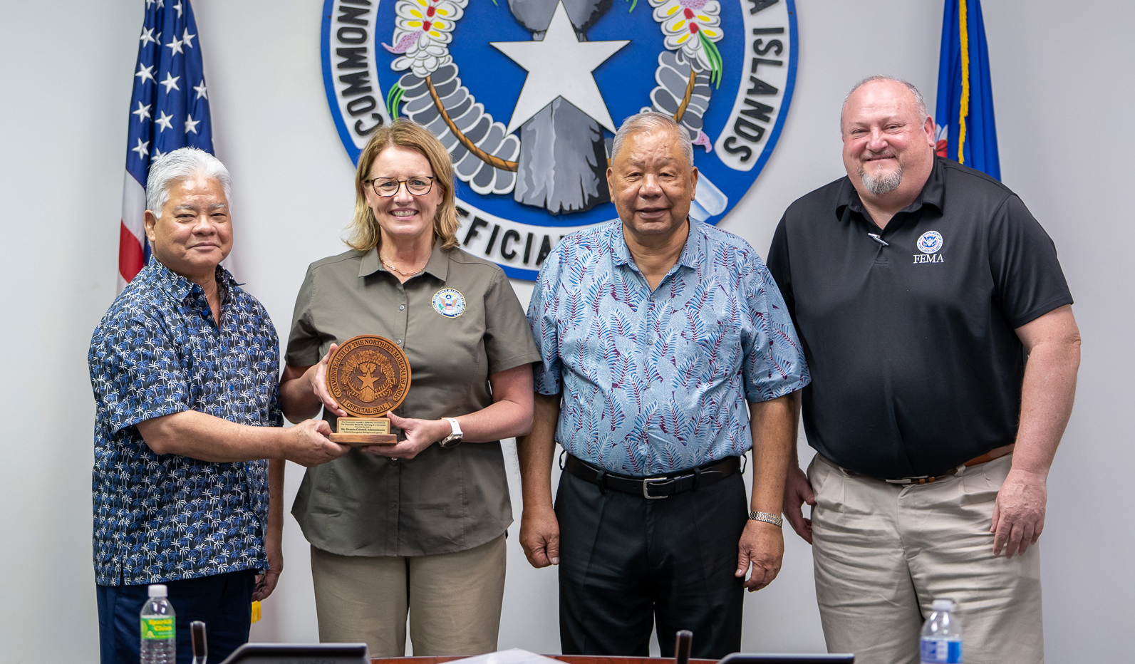 Federal Emergency Management Agency Administrator Deanne Criswell, 2nd left, FEMA Region IX Administrator Robert Fenton, right, and FEMA Public Assistance Director Robert Pesapane — not pictured — visited the CNMI last week to look into active FEMA projects in the Commonwealth. Criswell, Fenton, Pesapane, along with other FEMA officials, visited Northern Marianas College, Hopwood Middle School, the Emergency Operations Center, the Commonwealth Utilities Corporation, and ongoing permanent housing construction sites. Photo shows Gov. Arnold I. Palacios, left, and Lt. Gov. David M. Apatang, right, present a plaque of appreciation to Criswell and FEMA.