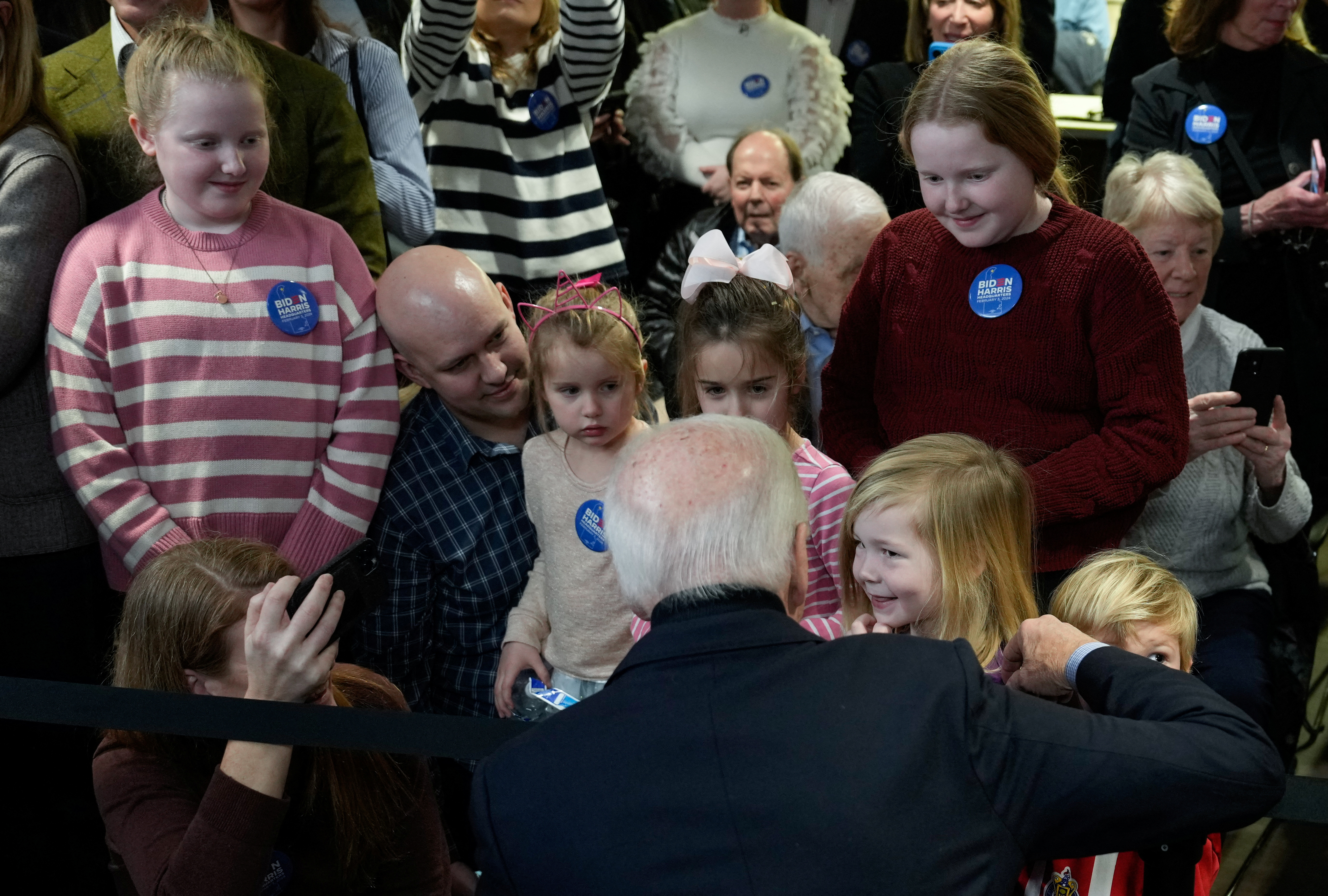 U.S. President Joe Biden speaks with children during the opening of the Biden for President campaign office in Wilmington, Delaware, U.S., February 3, 2024. 
