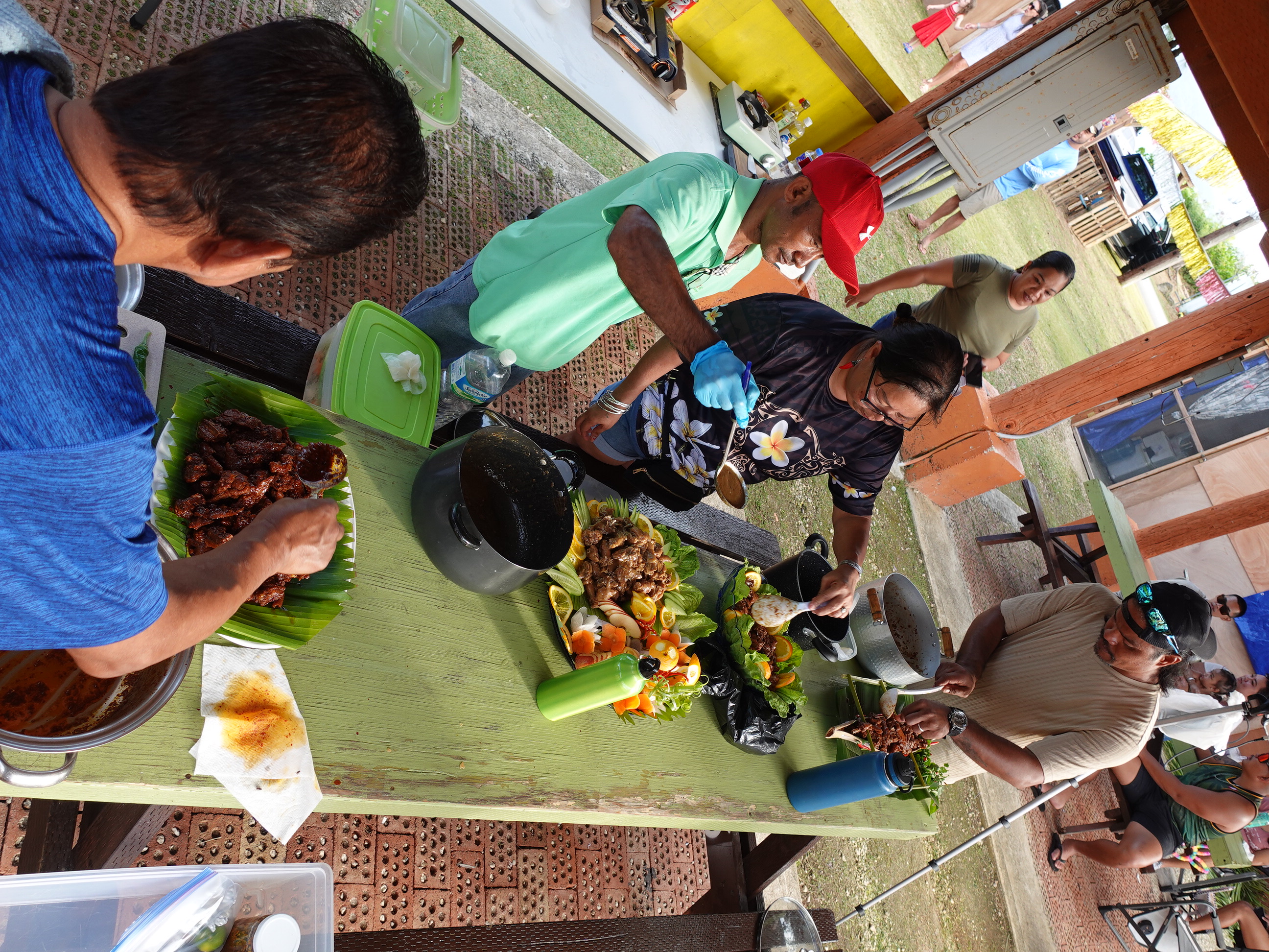 Eventual 1st place winner Bill Cing, left, and other home cooks prepare their entries for the Estafao (spicy beef stew) Cooking Contest on Feb. 17, 2024, at the 20th  Annual Tinian Hot Pepper Festival.