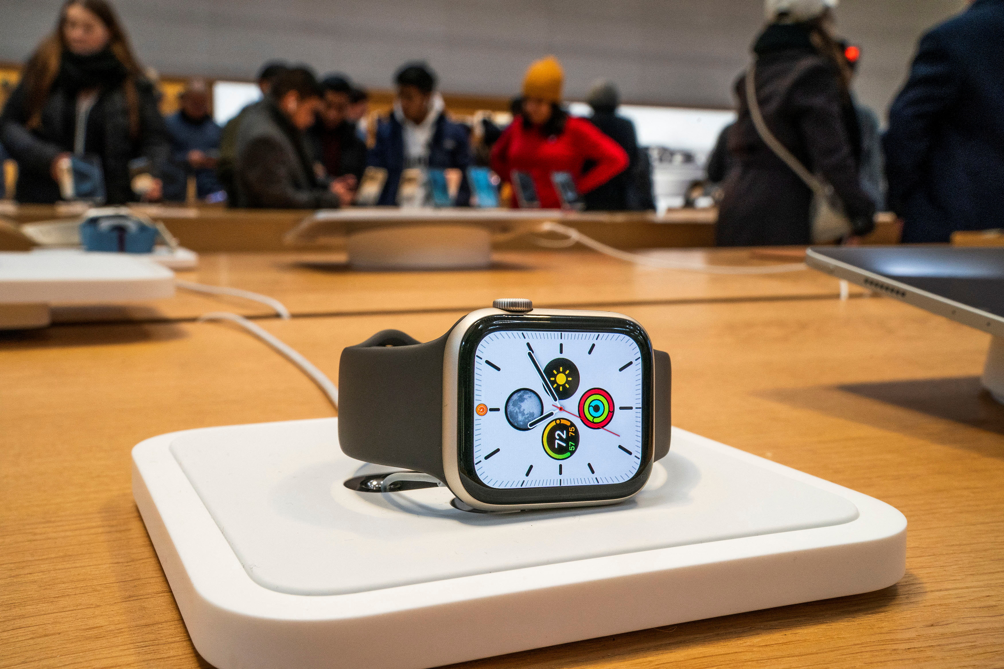 An Apple smartwatch is displayed as customers visit the Apple store in New York, U.S., December 26, 2023. 