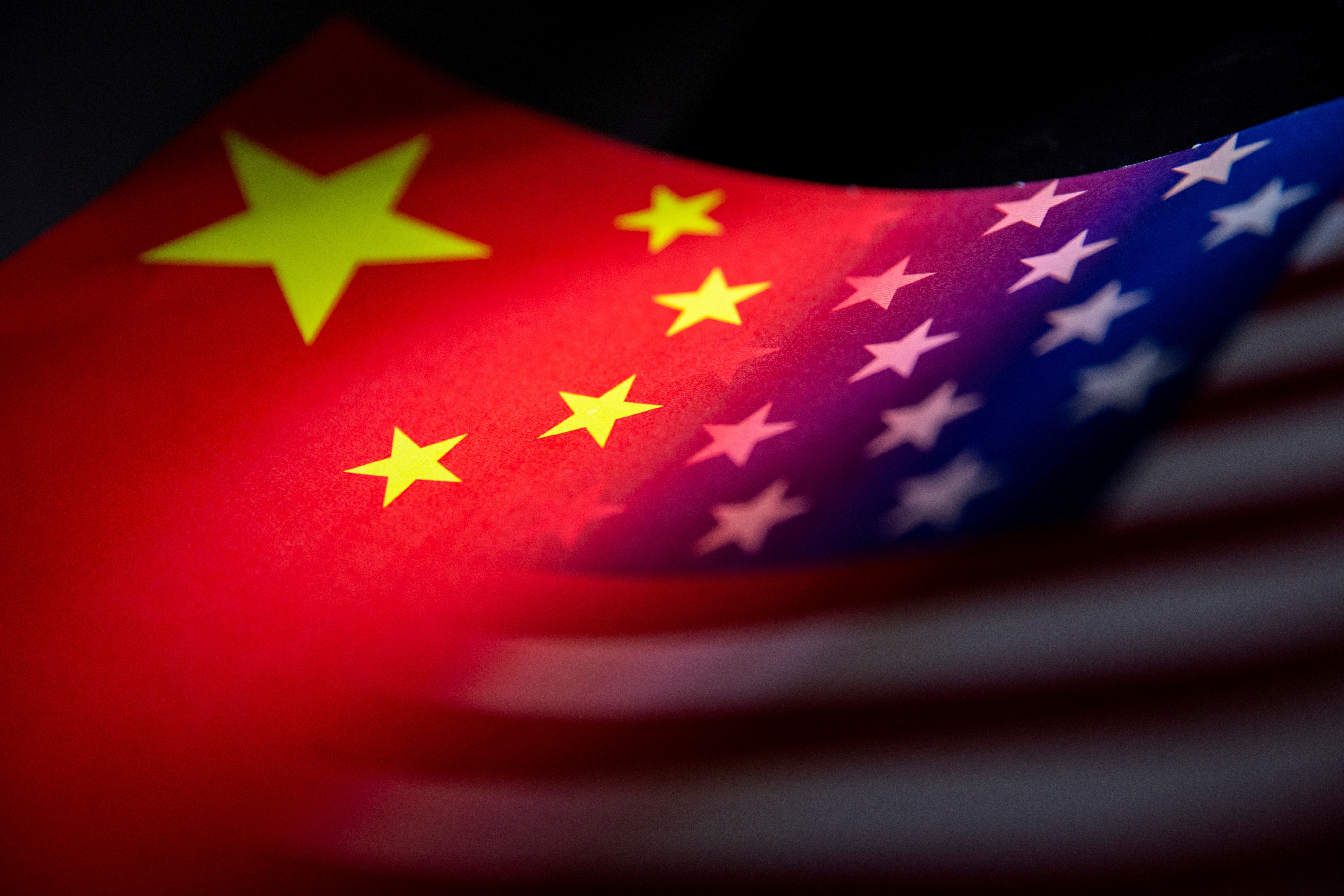 China's and U.S.' flags are seen printed on paper in this illustration taken January 27, 2022. 