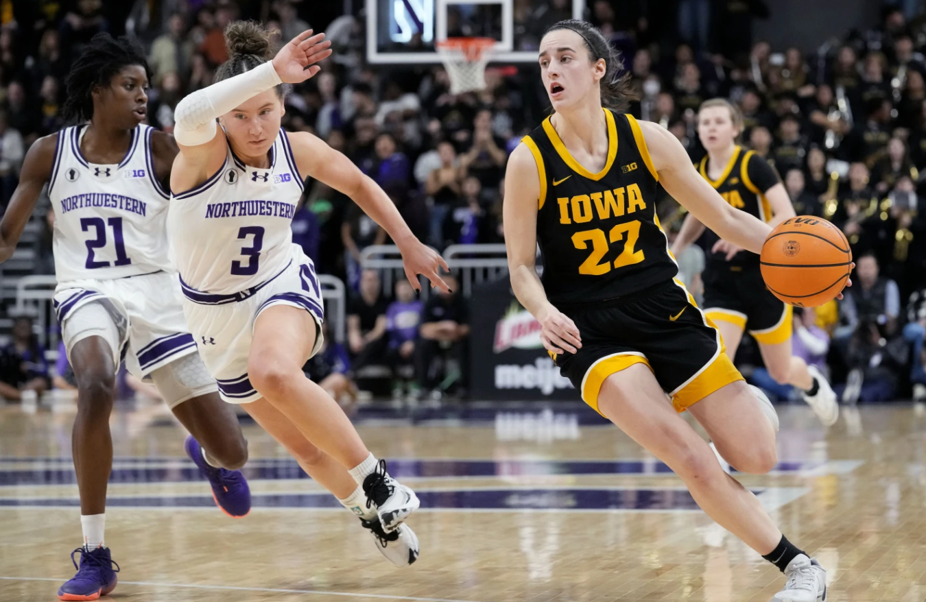 Iowa guard Caitlin Clark (22) drives as Northwestern guard Maggie Pina defends during the first half of an NCAA college basketball game in Evanston, Ill., Wednesday, Jan. 31, 2024.