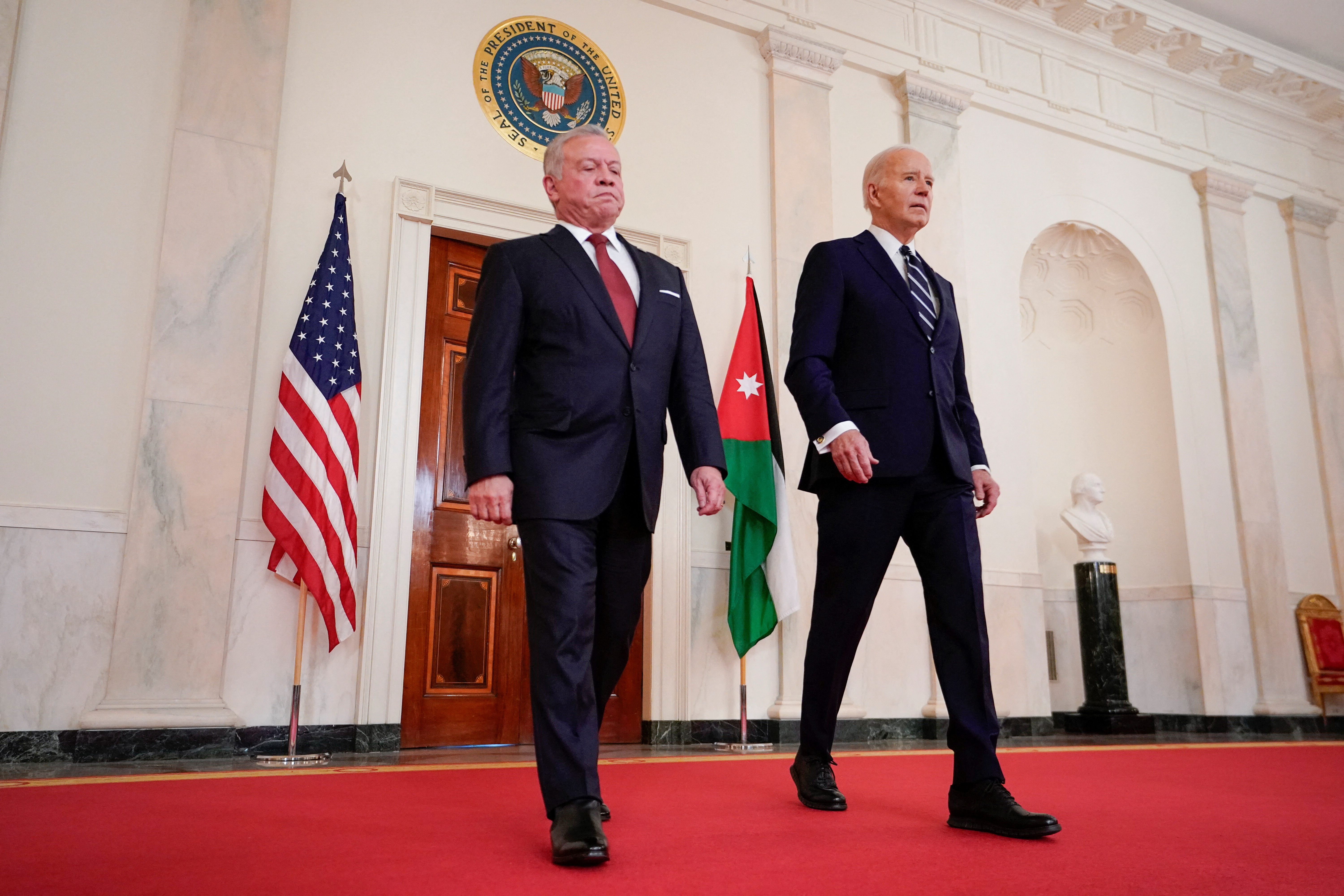 U.S. President Joe Biden walks with Jordan's King Abdullah, as they attend a press conference, following their meeting, at the White House in Washington, U.S., February 12, 2024. 