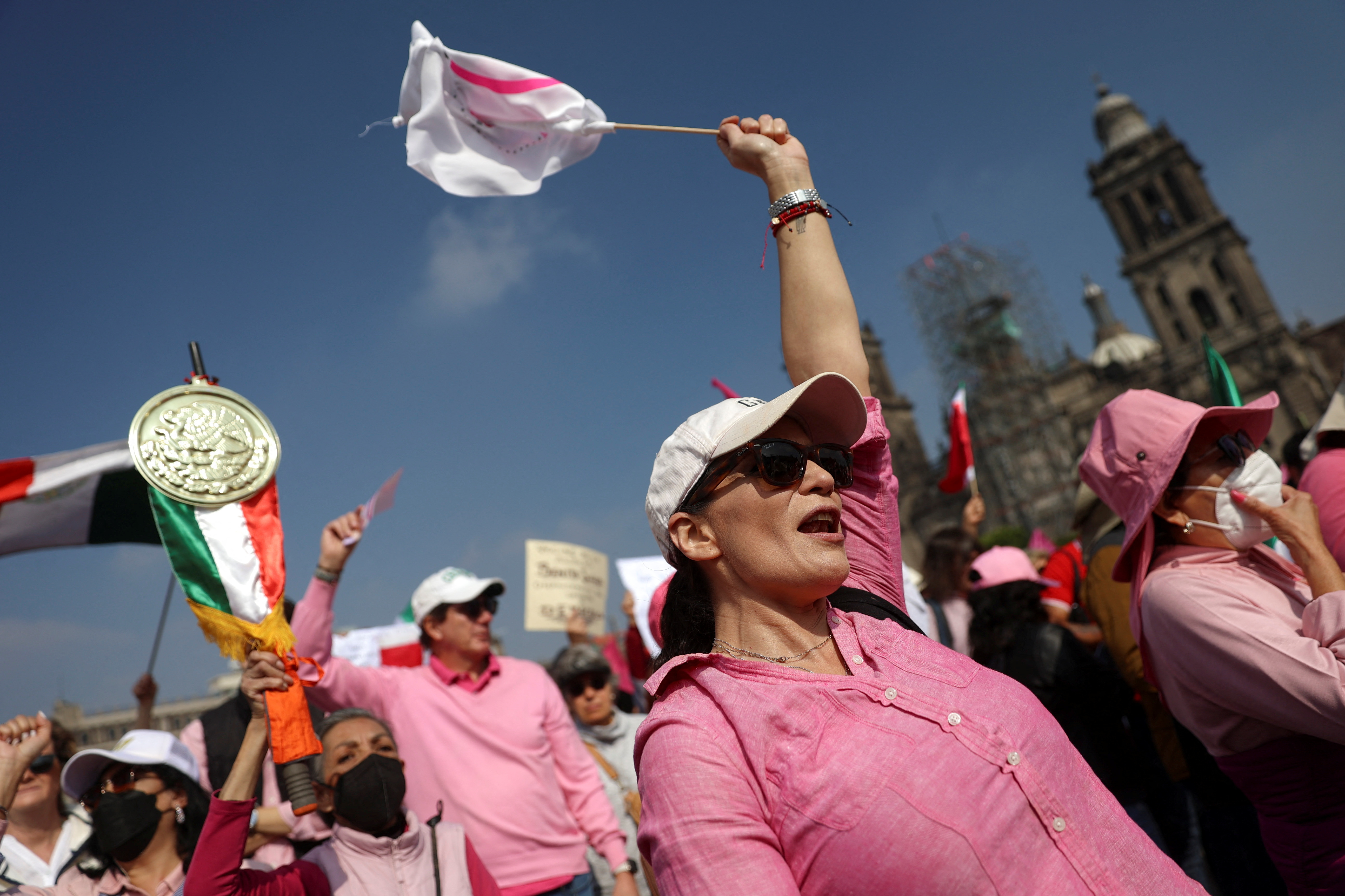 A demonstrator waves a flag as Mexican opposition groups march against government of Mexico's President Andres Manuel Lopez Obrador calling to 'defend democracy', in Mexico City, Mexico, February 18, 2024. 