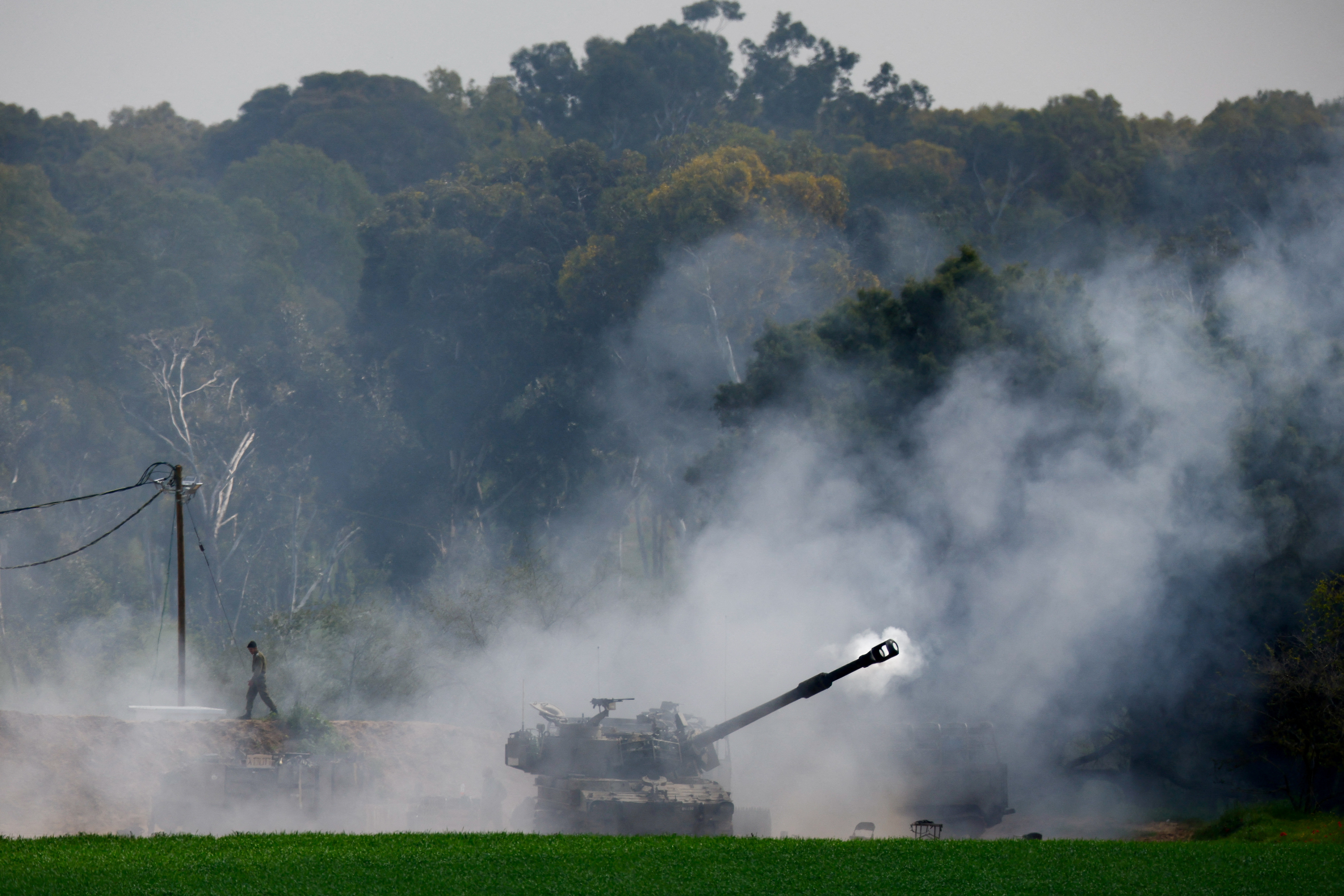 A soldier stands near an artillery unit after it fired towards Gaza, amid the ongoing conflict between Israel and the Palestinian Islamist group Hamas, in Israel, February 22, 2024. 