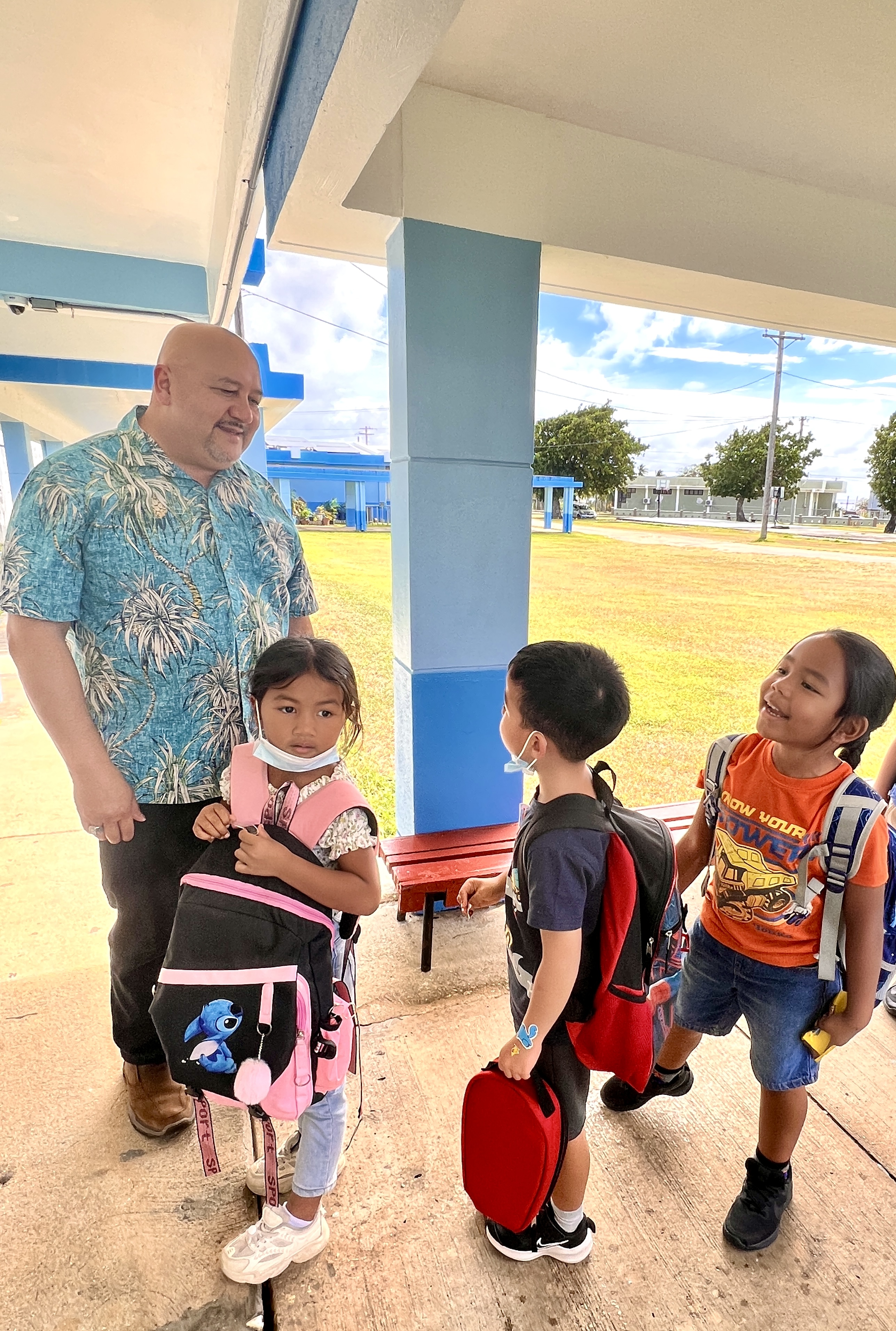 Kindergarten pupils greet Education Commissioner Dr. Lawrence Camacho during his visit to Tinian Elementary School last week. 