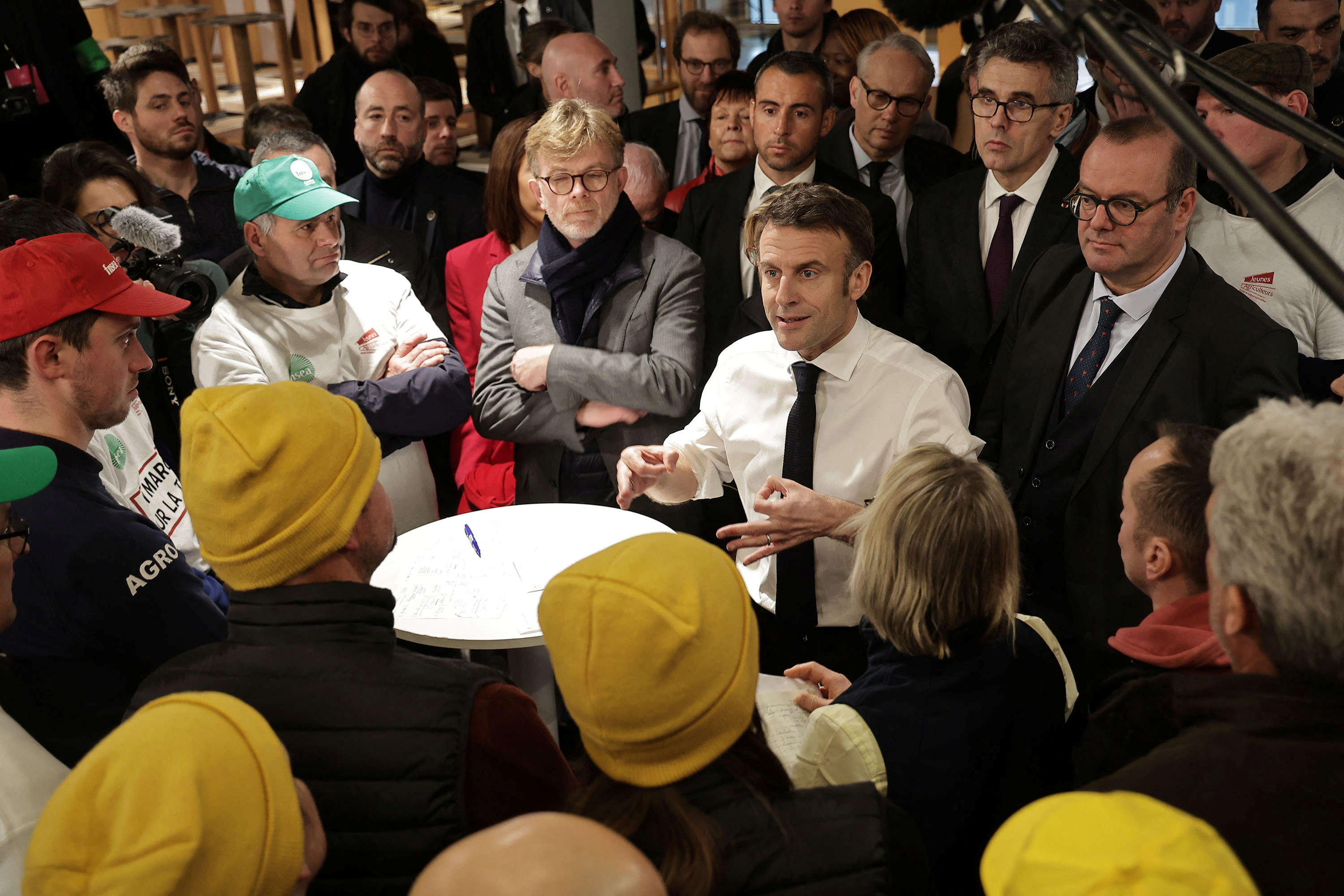 French President Emmanuel Macron, flanked by France's Minister for Agriculture and Food Sovereignty Marc Fesneau, gestures as he speaks with members of the agricultural unions National Federation of Agricultural Holders' Unions (FNSEA), Young Farmers (JA), Rural Coordination (CR) during the opening day of the 60th International Agriculture Fair (Salon de l'Agriculture), in Paris, France, February 24, 2024. 