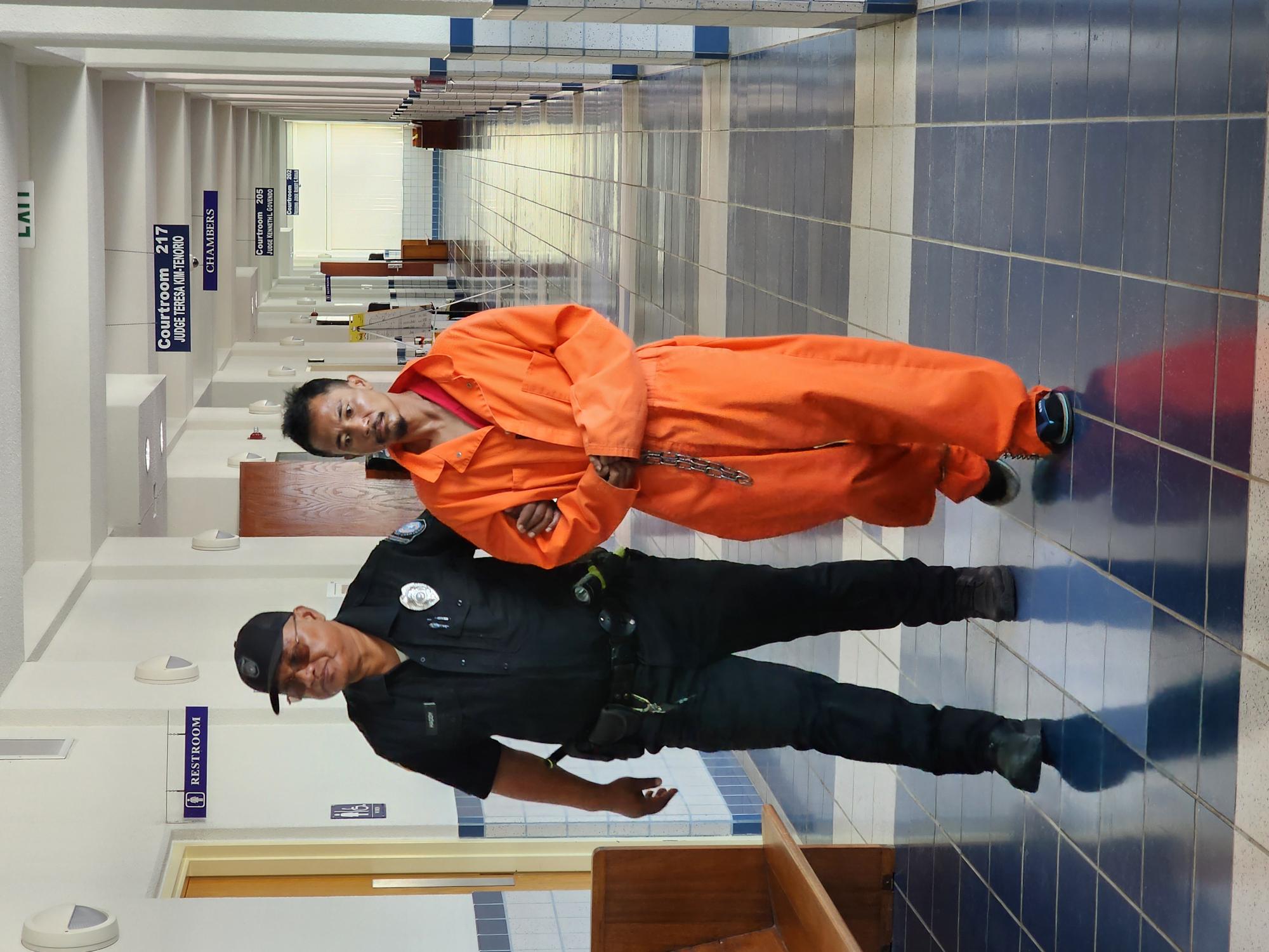 Martin T. Castro Jr., right, is escorted by a Corrections officer at the local courthouse for a bail hearing on Friday.