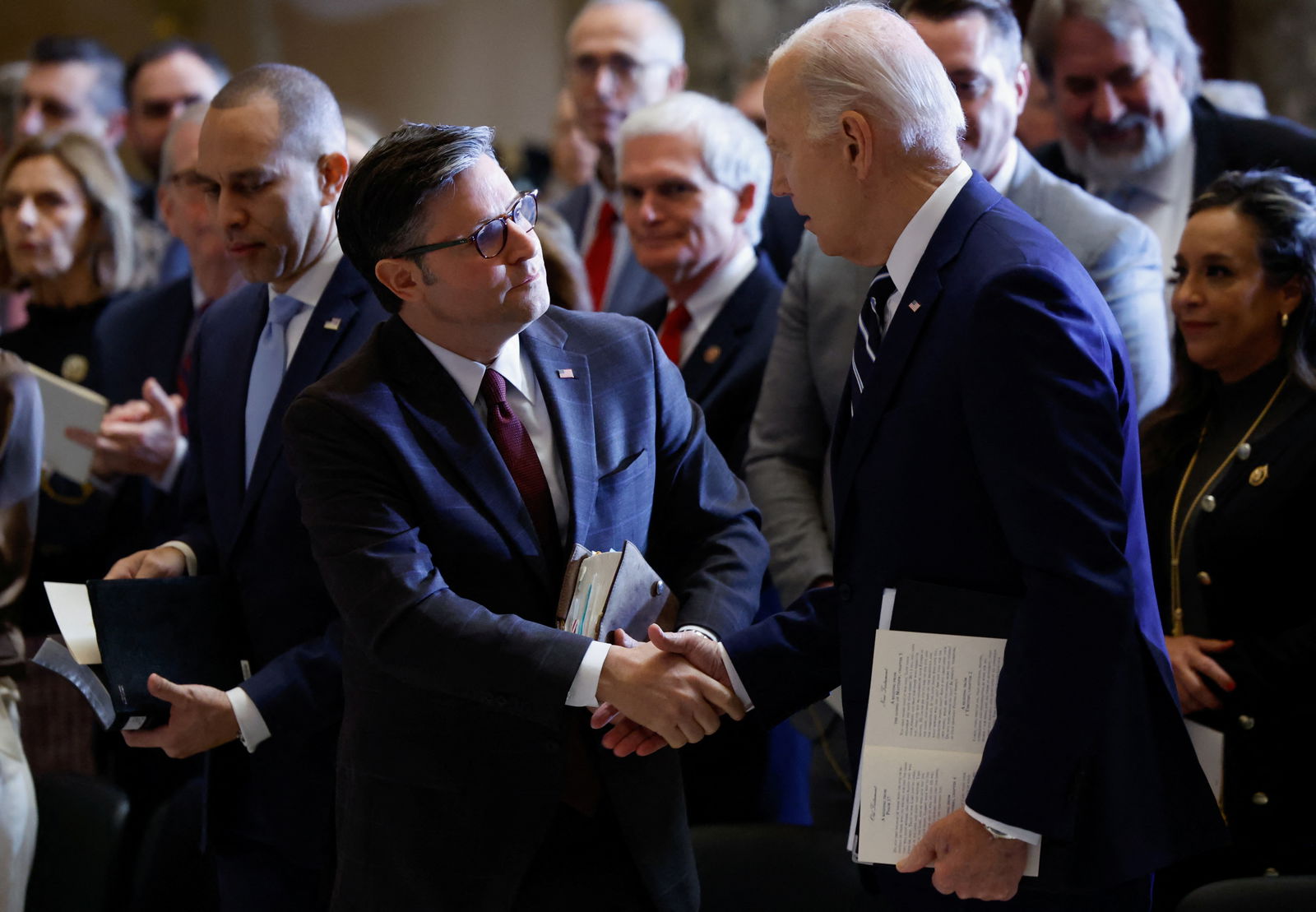 File photo: U.S. President Joe Biden shakes hands with U.S. House Speaker Mike Johnson (R-LA) during the annual National Prayer Breakfast at the U.S. Capitol in Washington, D.C., U.S., February 1, 2024. 