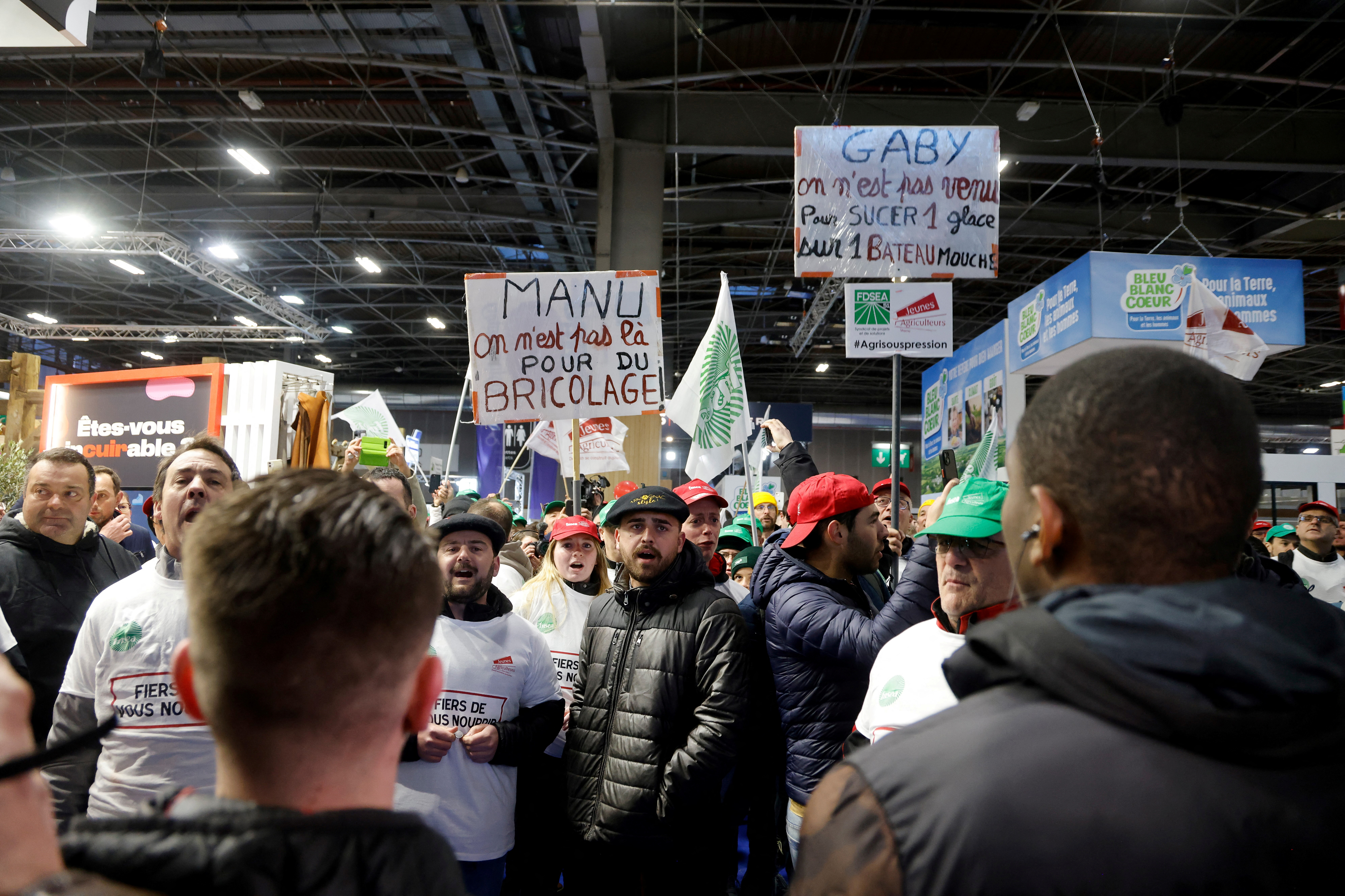 Protesters wearing shirts with the logos of the FNSEA and Jeunes Agriculteurs farmers' unions gather to protest at the opening of the 60th International Agriculture Fair (Salon de l'Agriculture) at the Porte Versailles exhibition centre in Paris, France, February 24, 2024. 