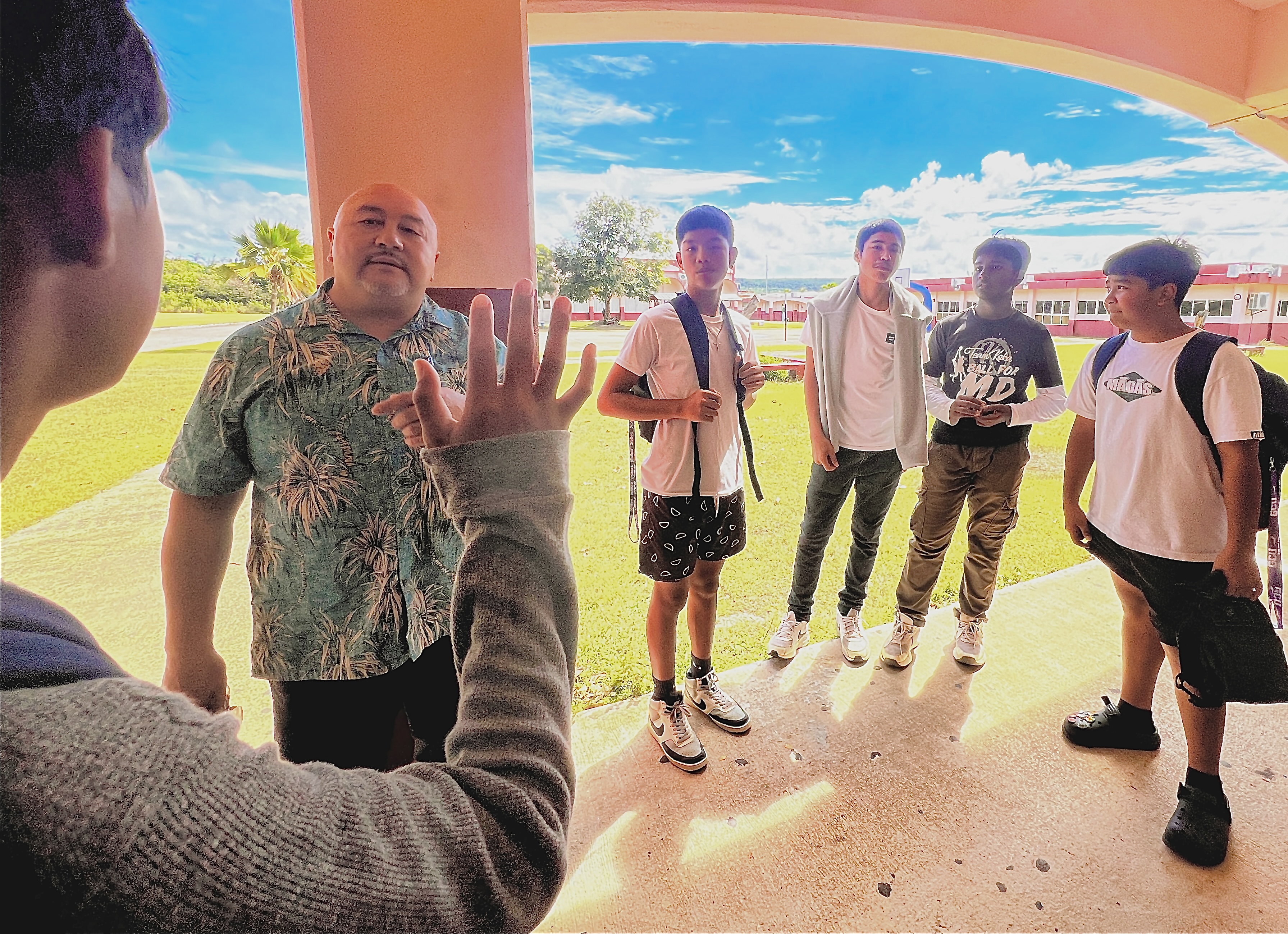 Education Commissioner Dr. Lawrence Camacho listens to a Tinian Middle School student. 