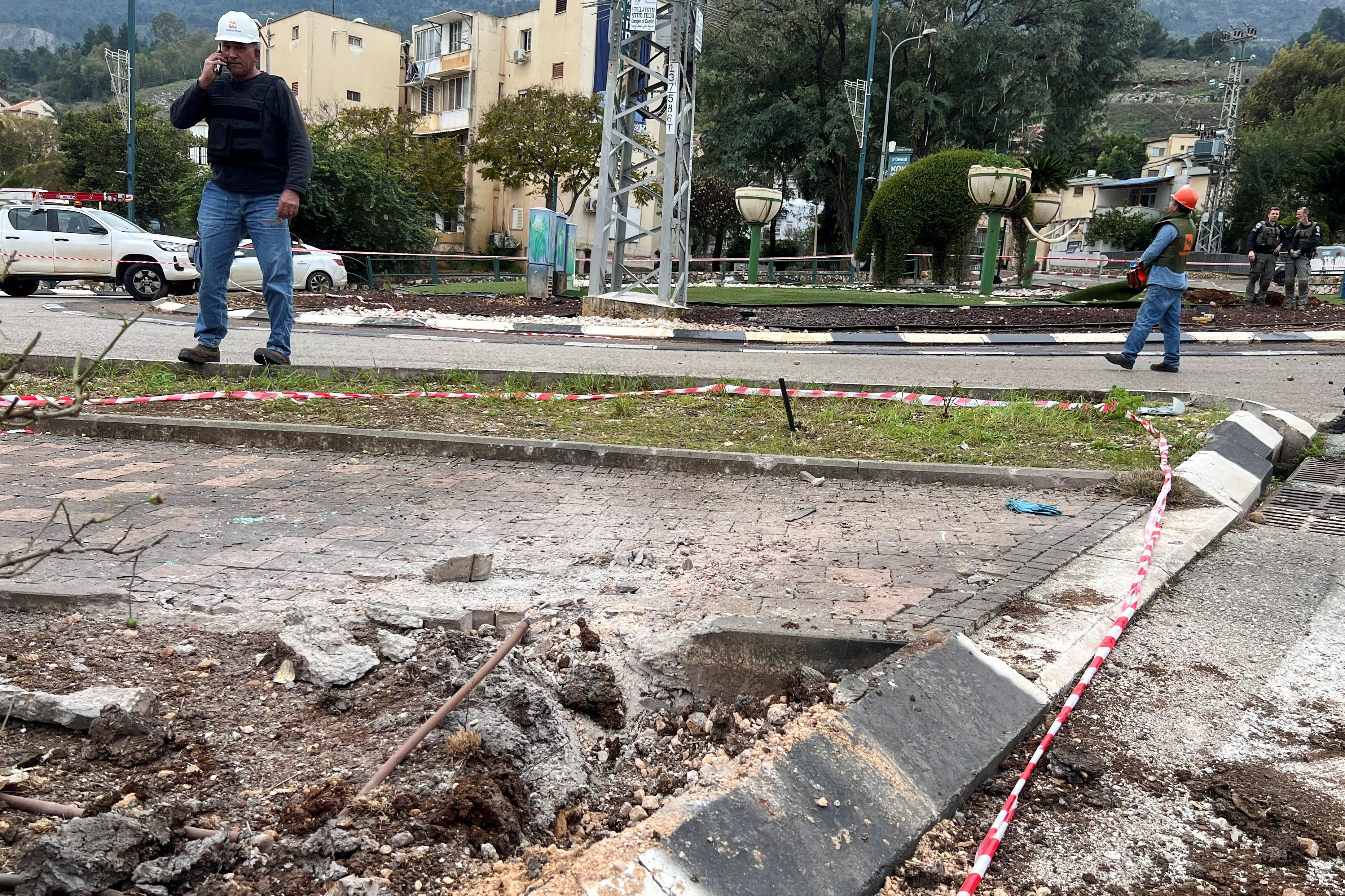 People work in the area where a rocket landed after it was fired from Lebanon, amid the ongoing conflict between Israel and the Palestinian Islamist group Hamas, in Kiryat Shmona close to Israel's border with Lebanon in northern Israel February 13, 2024. 