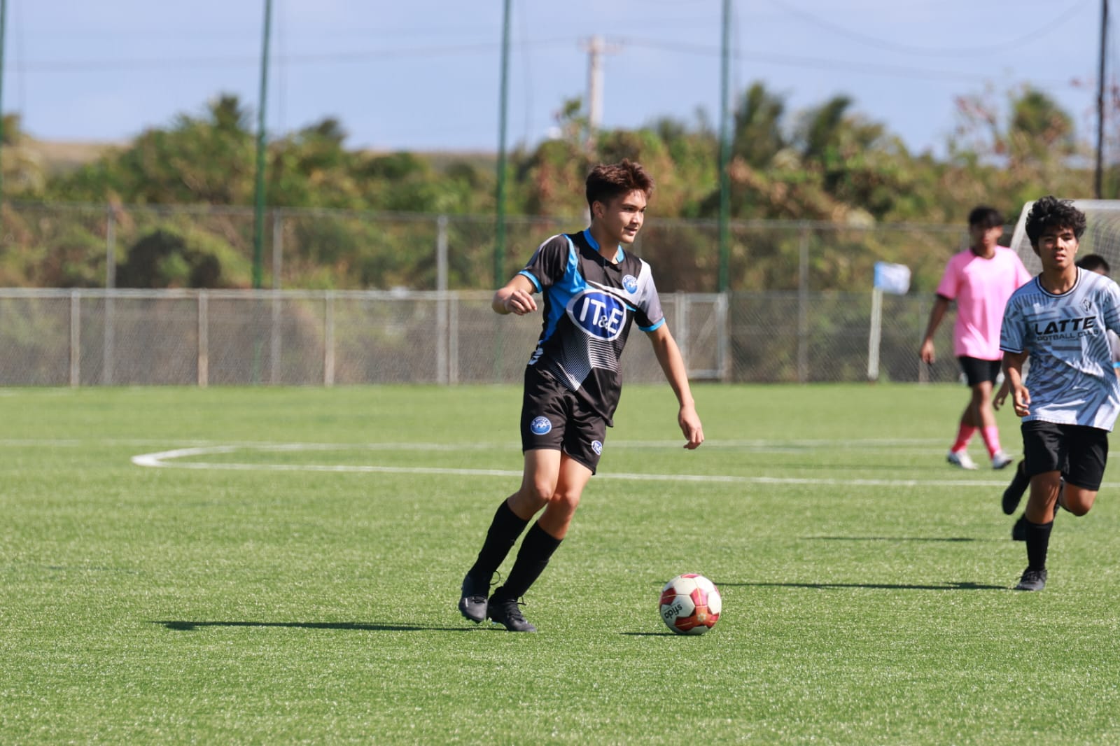 An MP United Football Club player looks on as he sets up the play during a game against the Latte Football Club in U14 boys division of the 2024 TakeCare Youth Soccer League at the NMI Soccer Training Center in Koblerville on Saturday. 