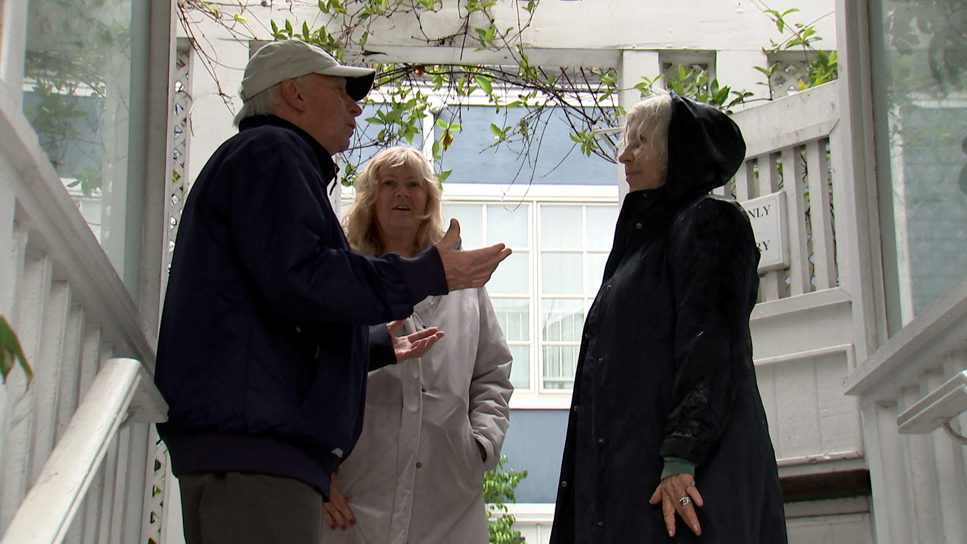 Alice White-Zmigrocki, 66, and her husband Joe Zmigrocki, 74, speak with Inn at Playa del Rey's owner Susan Zolla as workers (not pictured) pump flood water from the street surrounding the place, after heavy rains hit Southern California, in Los Angeles, California, U.S., February 5, 2024, as seen in this scree grab taken from a video. 