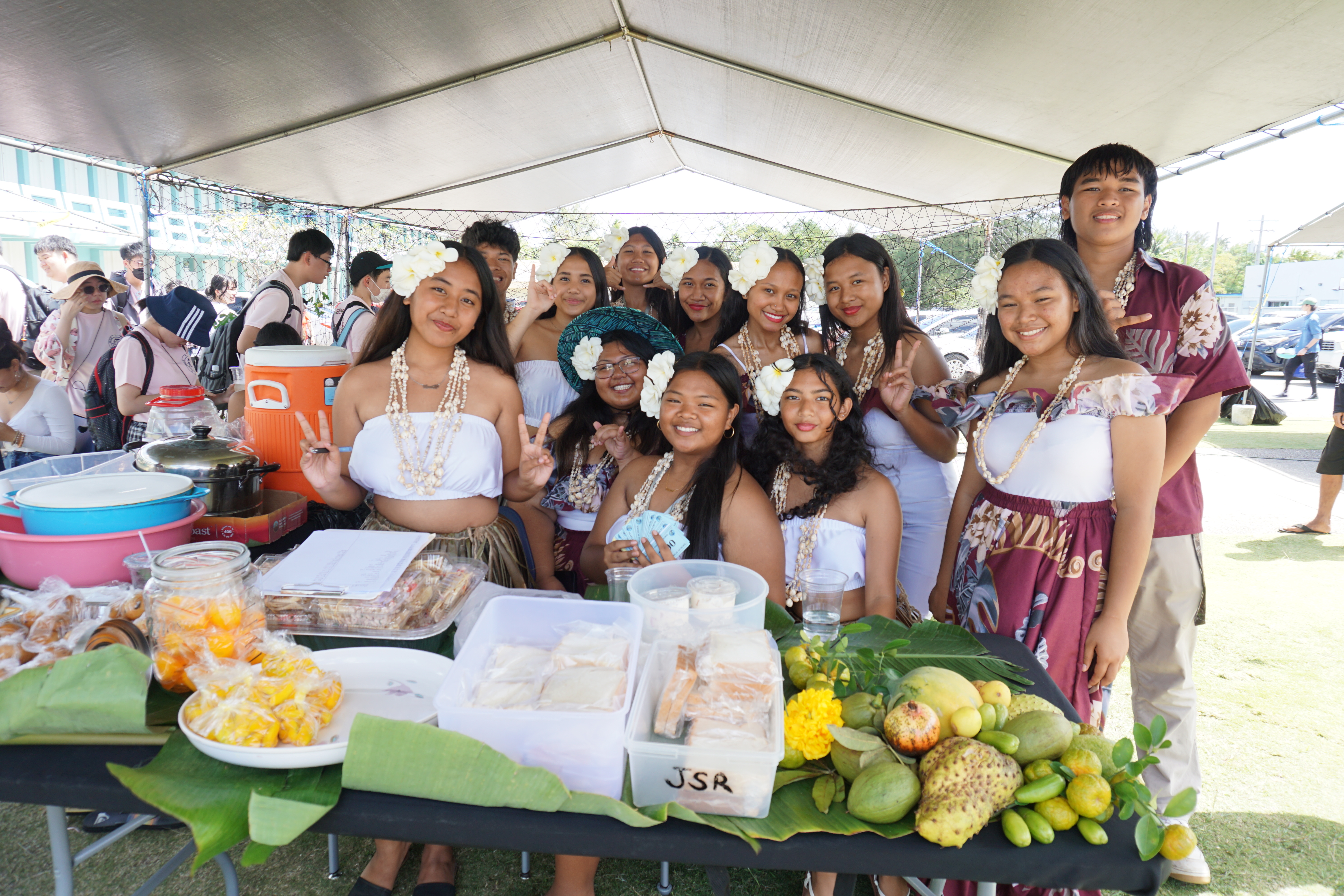 MHS Polksai Chamorro Club members gather for a photo at their canopy.