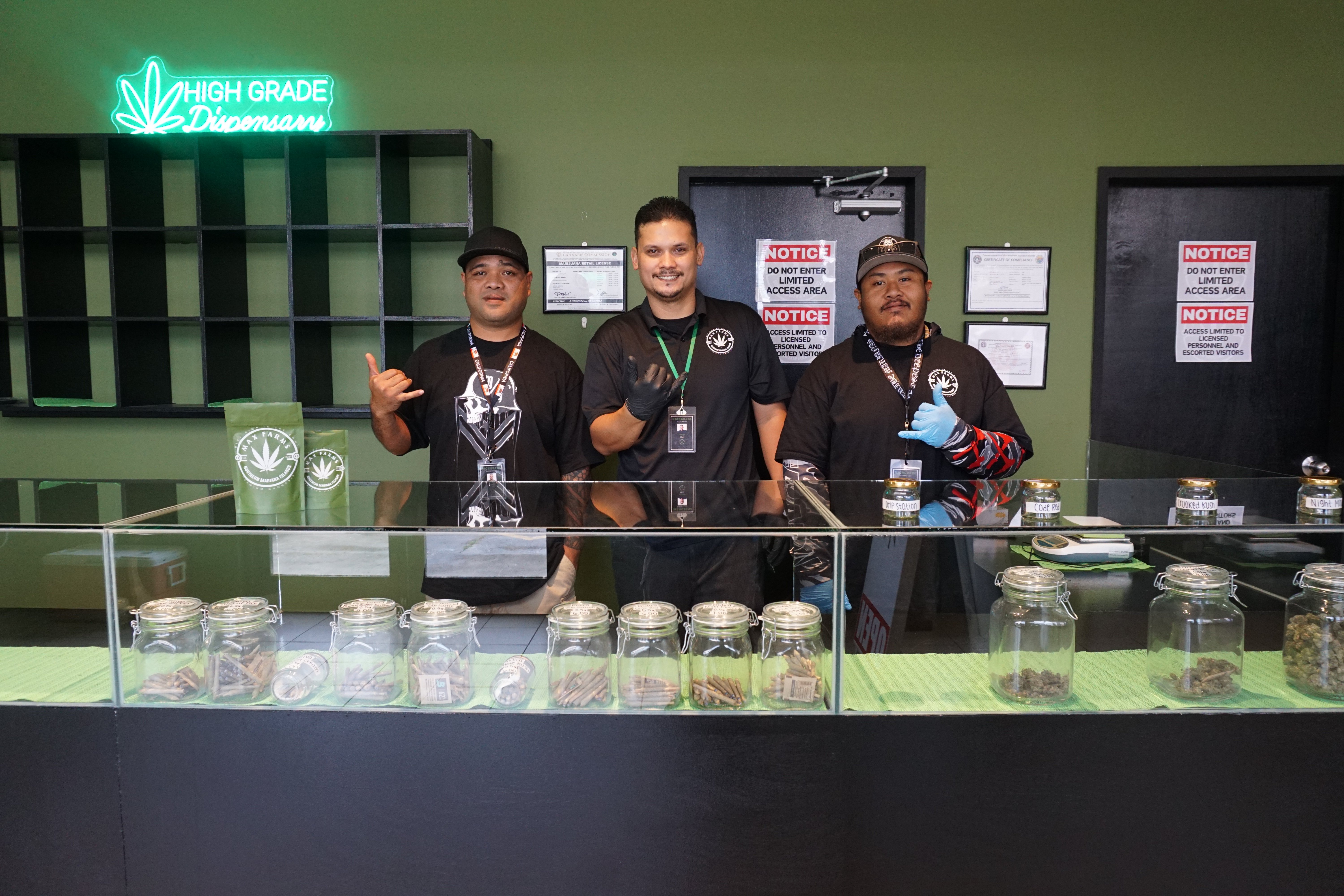 From left, Jermane Borja, Chris Meyers and Shawn Muna pose behind the counter of the island's newest cannabis dispensary.