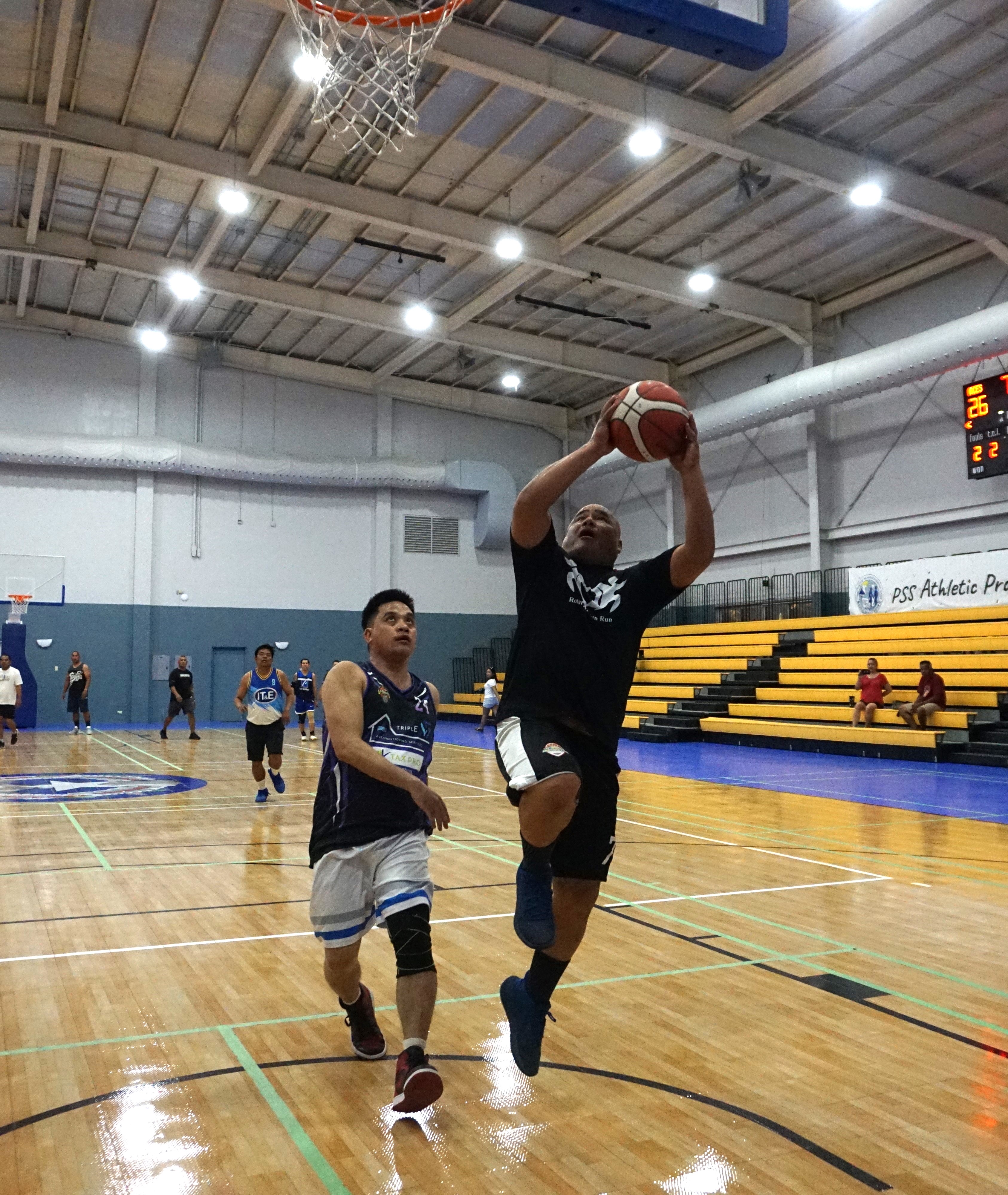 The Old Aces' Tony Diaz rises up for the fastbreak finish during a game against Triple L/Tax Pro in the Masters “Internal” Basketball League at the Ada gym on Saturday.