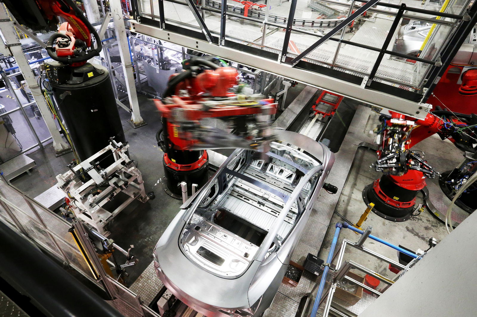 Production robots work on Tesla Model 3 on the assembly line at the Tesla factory in Fremont, California, on July 18, 2018. (Ray Chavez/Bay Area News Group/TNS)