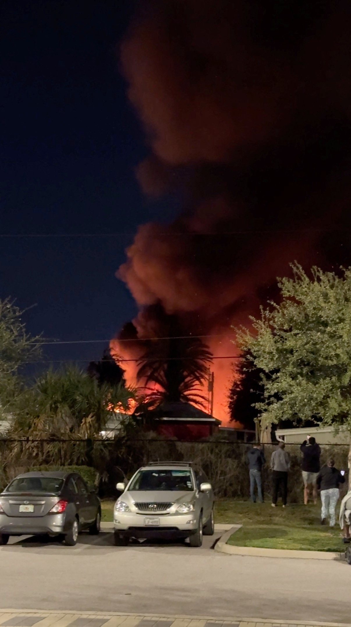 A plume of smoke rises after a small plane crashes in a trailer park in Clearwater, Florida, U.S., February 1, 2024, in this screen grab obtained from a social media video. 