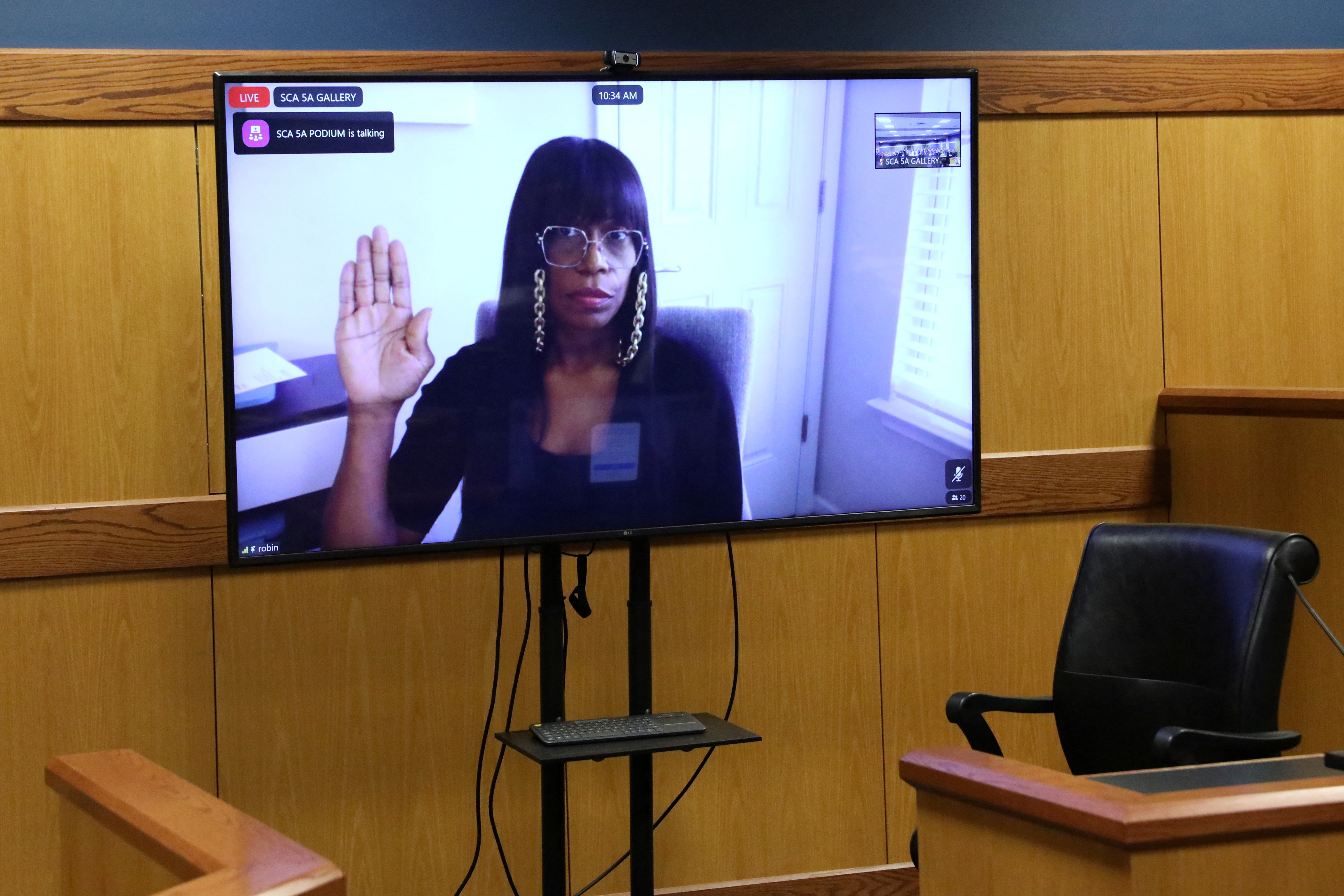 Witness Robin Yeartie is seen on a screen as she is sworn in during a hearing in the case of State of Georgia v. Donald John Trump at the Fulton County Courthouse in Atlanta, Georgia, U.S., February 15, 2024. 