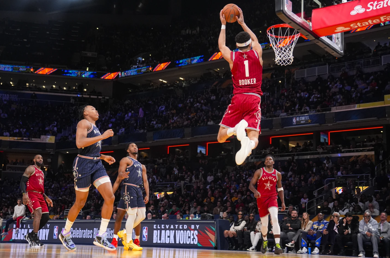 Phoenix Suns guard Devin Booker (1) goes up for a dunk during the first half of an NBA All-Star game in Indianapolis, Sunday, Feb. 18, 2024.