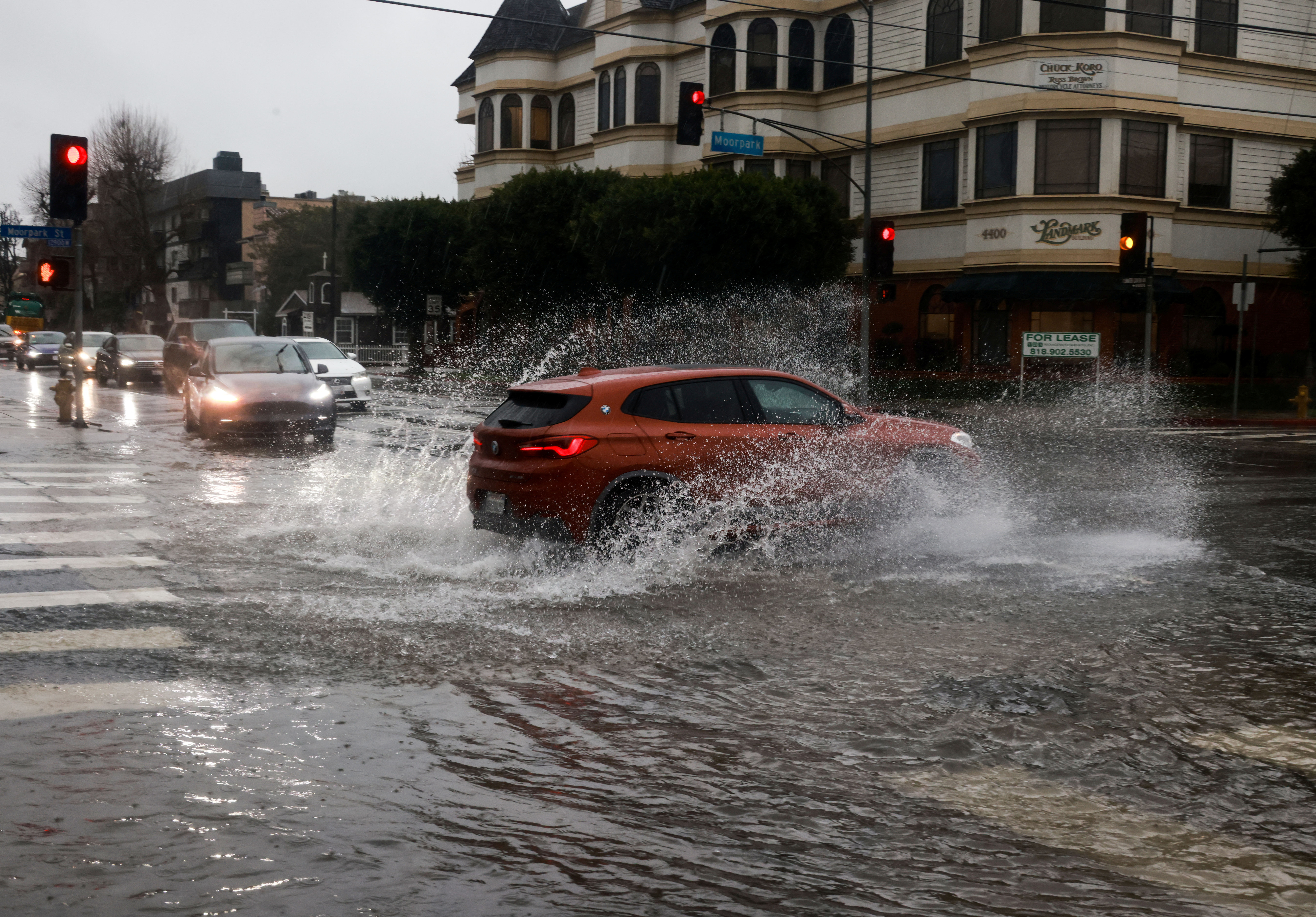 Cars drive on flooded streets, during the ongoing rain storm in Studio City, California, U.S., February 5, 2024. 