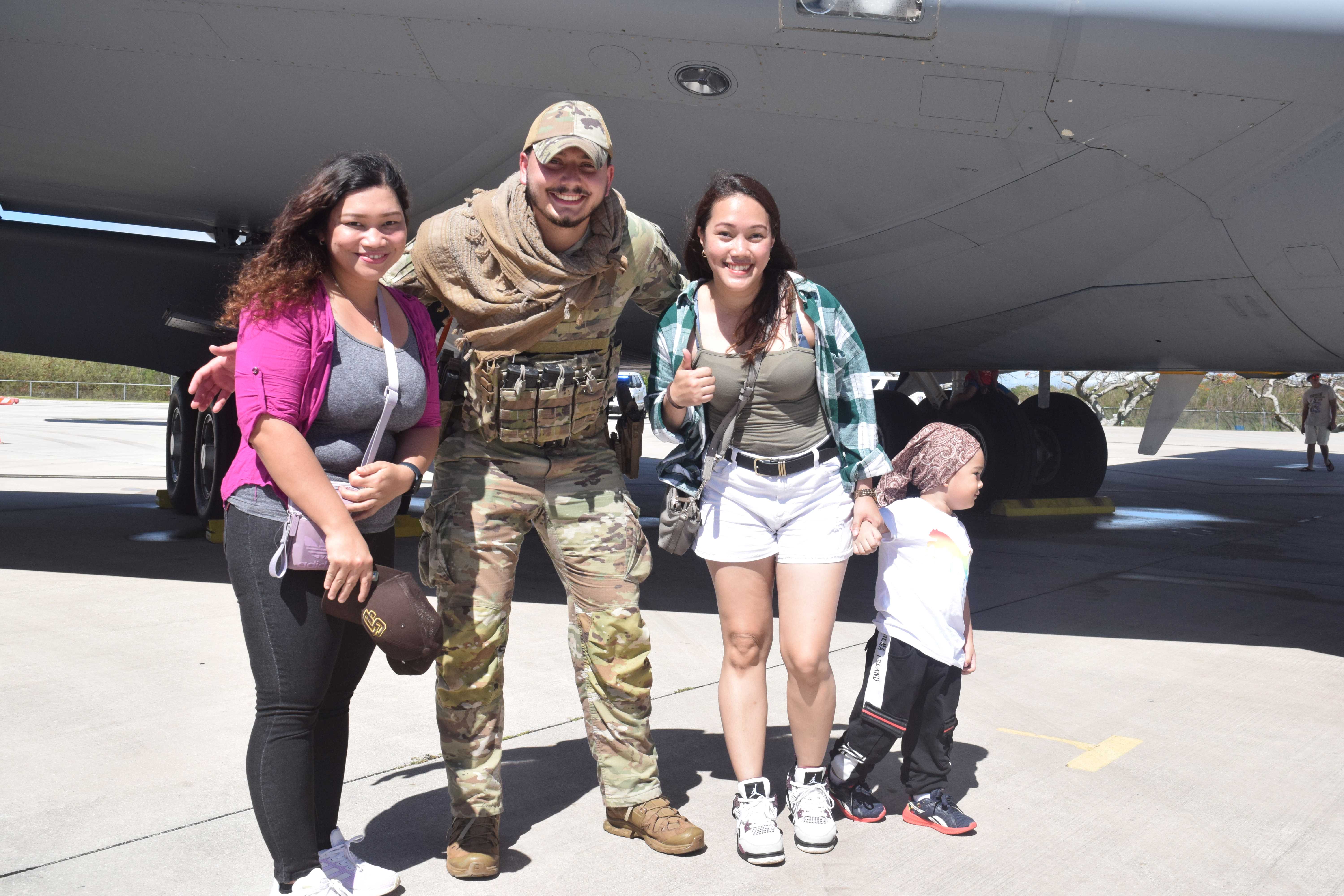 Saipan residents Queeny Rose Ann Plaza, right, Joy Ibit, left, and two-year-old Zeb Eli Jonota pose with U.S. Air Force's Public Affair's Sia K. Kramer.