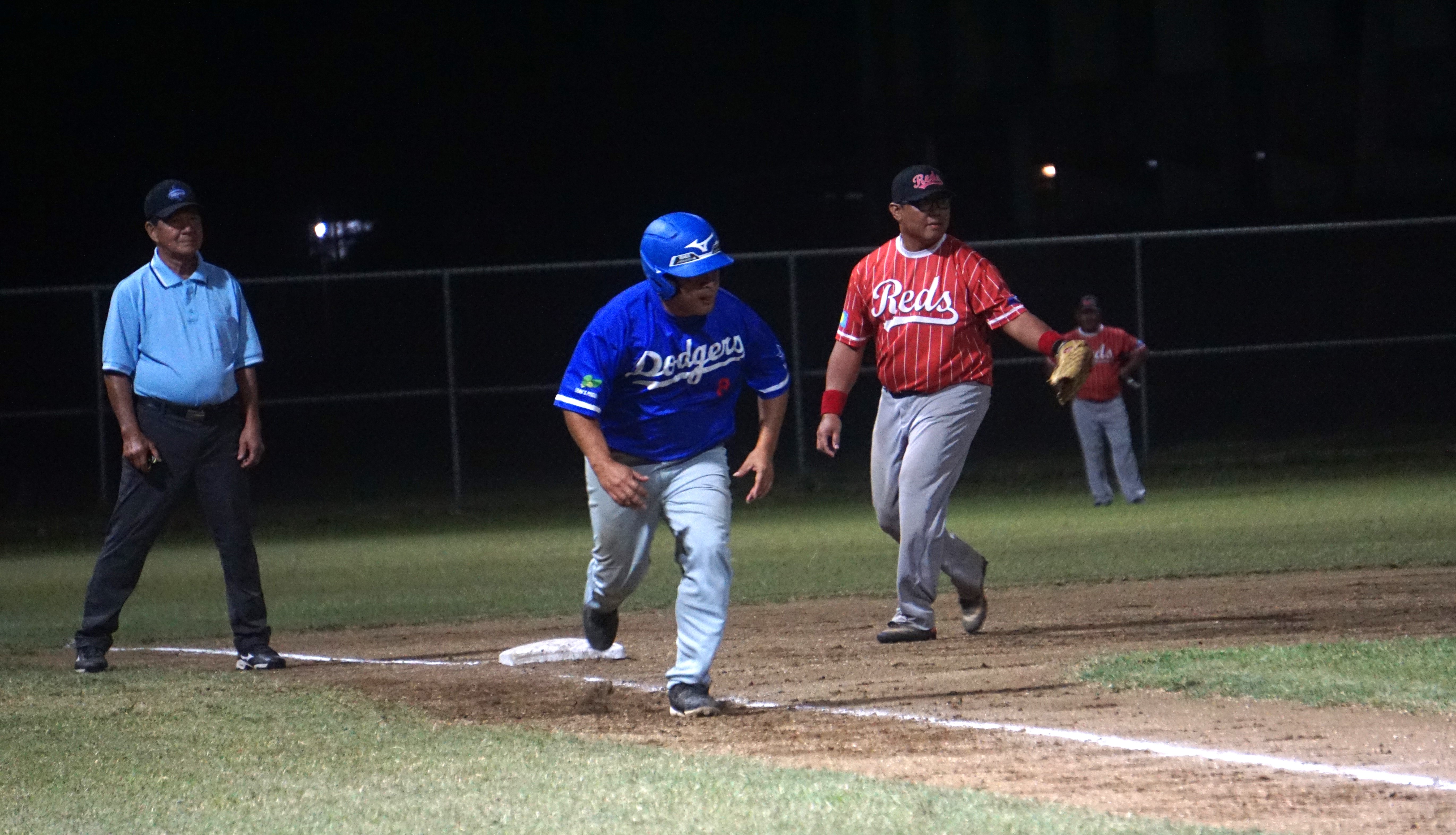 The Dodgers' Clint Quitugua attempts to steal home during the semifinal game against the Reds  at the Francisco "Tan Ko" Palacios Baseball Field on Thursday.