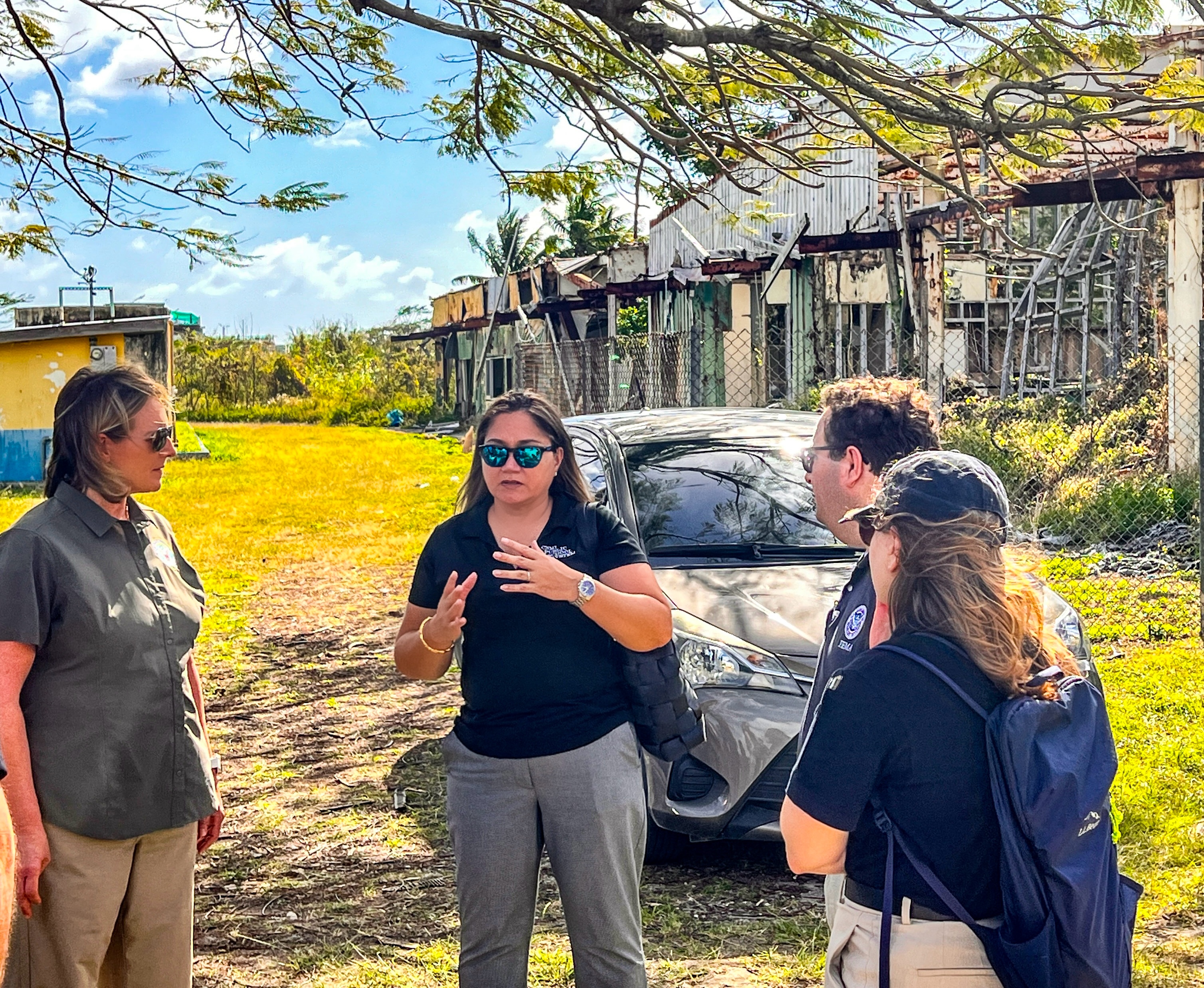 Acting Commissioner of Education Donna M. Flores, center, recounts to visiting Federal Emergency Management Agency Administrator Deanne Criswell, left, and her team how Super Typhoon Yutu destroyed six of Hopwood Middle School’s nine buildings. Criswell and her team toured Hopwood on Monday.