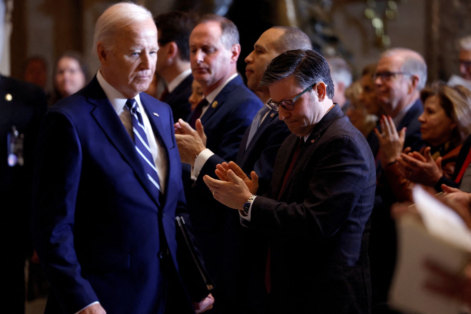FILE PHOTO: U.S. House of Representatives Democratic leader Hakeem Jeffries (D-NY) and U.S. House Speaker Mike Johnson (R-LA) applaud U.S. President Joe Biden during the annual National Prayer Breakfast at the U.S. Capitol in Washington, D.C., U.S., February 1, 2024. 