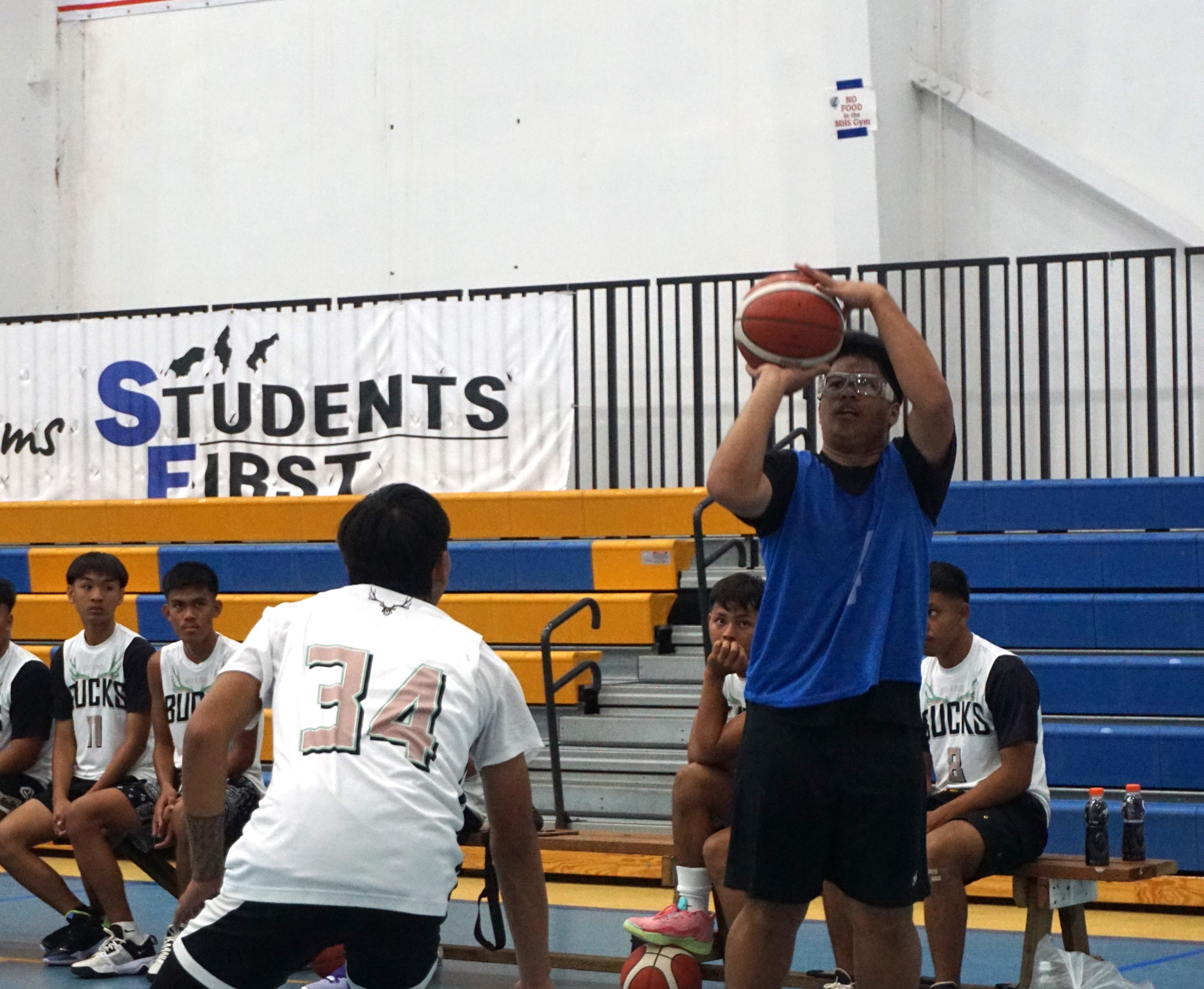 Marianas High School V's Marl Balignasay takes the three-point shot during a game against Rota’s Dr. Rita Hocog Inos Jr./Sr. High School in the boys high school division of the IT&E Interscholastic Basketball League SY23-24 at the MHS gym on Saturday.