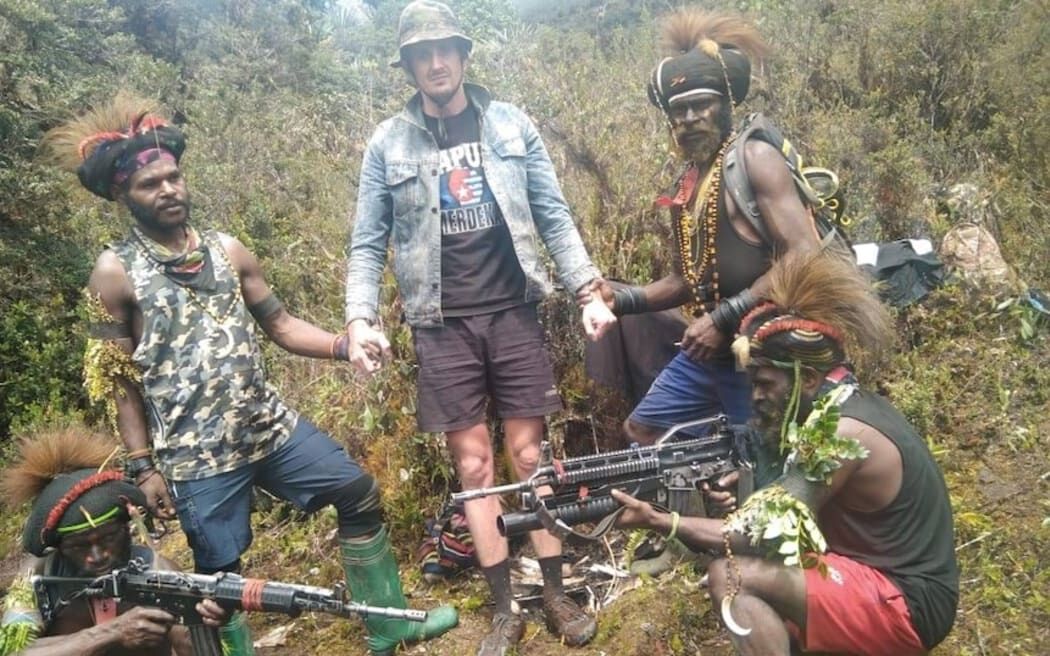 New Zealand pilot Philip Mehrtens was photographed with his rebel captors in Indonesia's Papua region. 