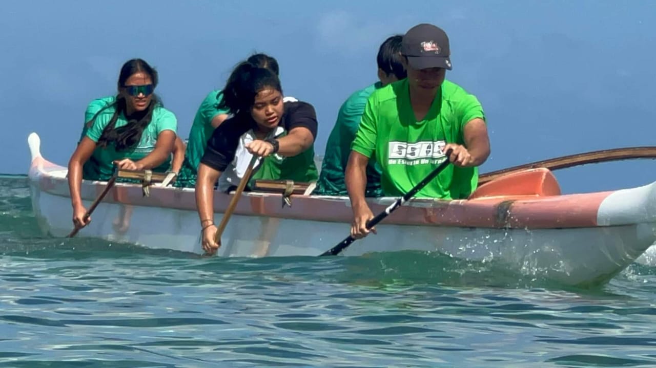 Saipan Southern High School's mixed team pushes through a turn during the first race in the co-ed high school division of the PSS Interscholastic Outrigger Race series at Kilili Beach on Saturday.