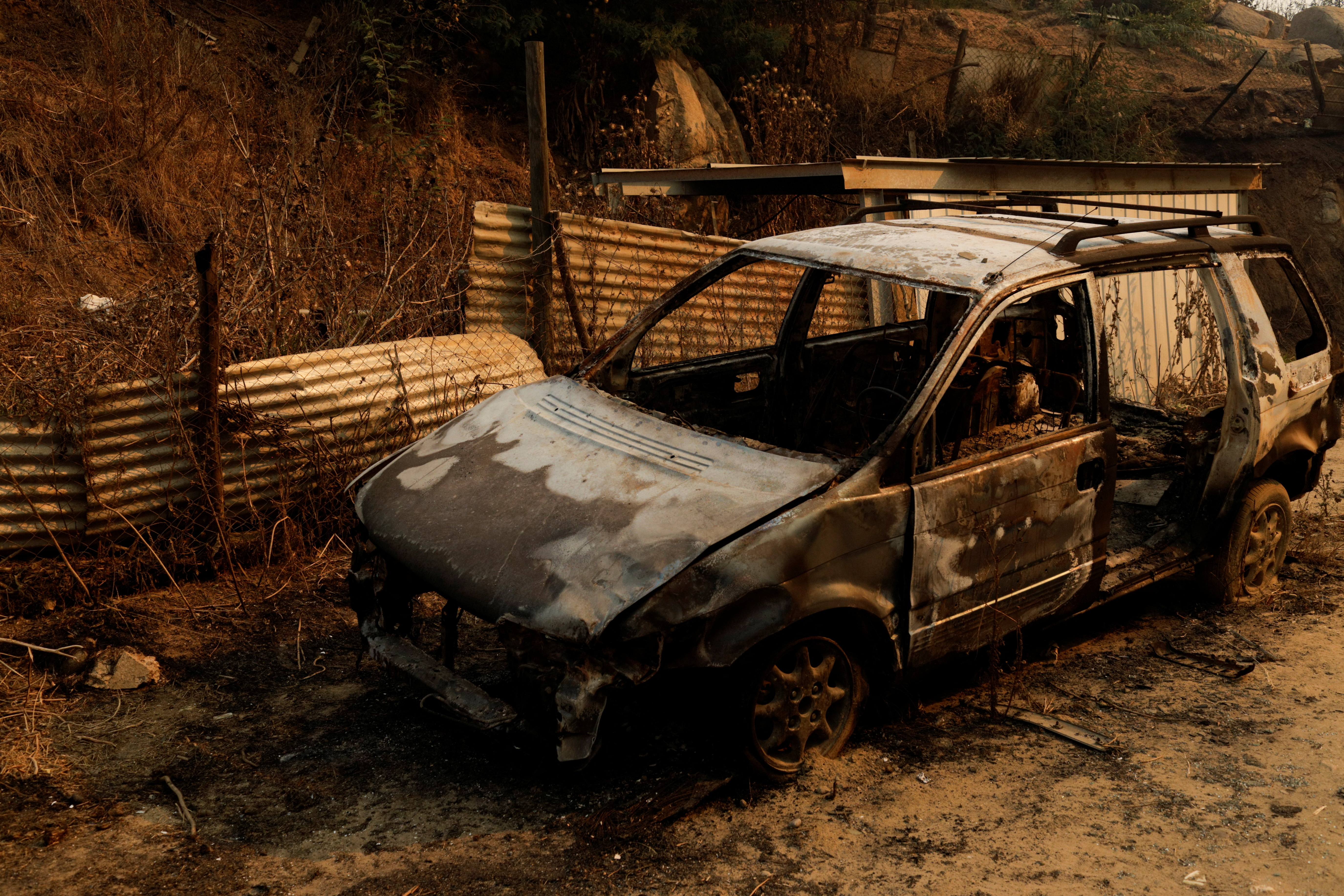 The remains of a burnt car stand following the spread of wildfires in Vina del Mar, Chile February 3, 2024. 