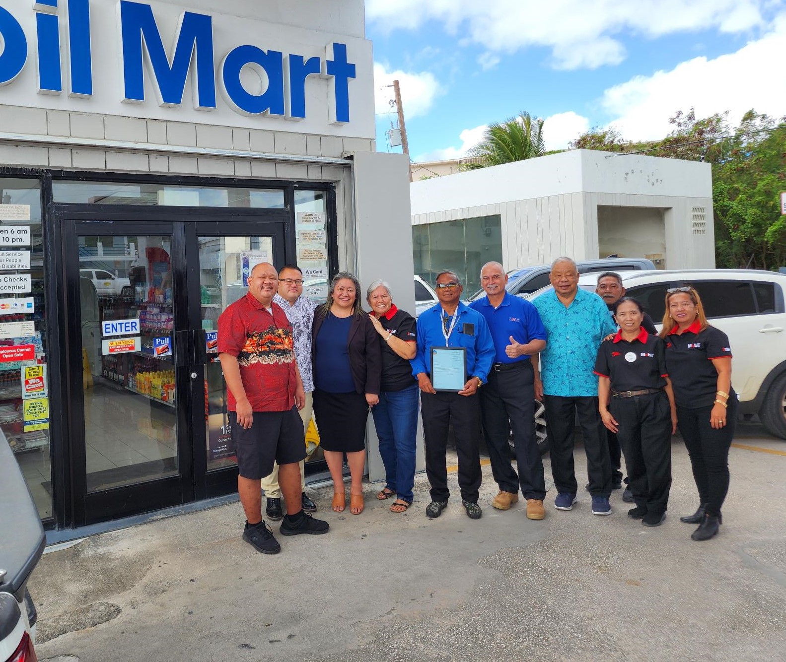 Max Aguon, 5th right, poses for a photo on Saturday with Rep. John Paul Sablan, Rep. Manny Castro, Senate President Edith Deleon Guerrero, Lt. Gov. David M. Apatang, JEMCO operators Edward and Jovita Flores, and CMG San Jose Mobil Gas Station staffers.