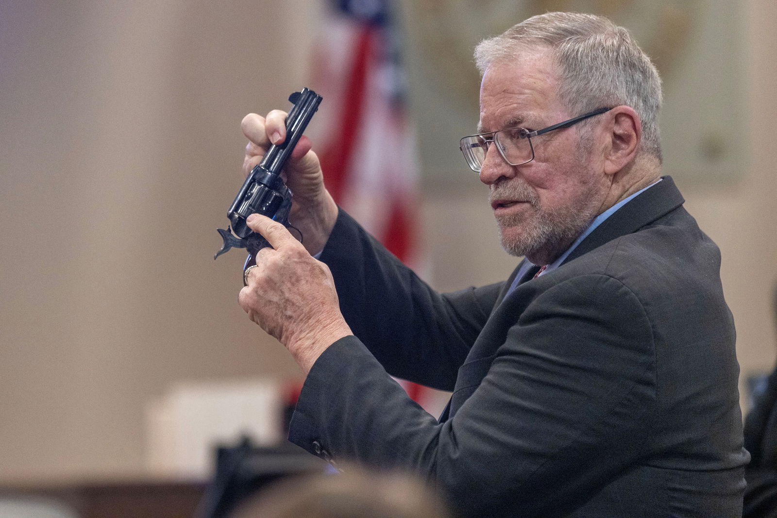 Lucien Haag, forensic science firearms evidence examination and shooting reconstruction expert witness, shows the jury a gun exactly like the evidence gun during the Hanna Gutierrez-Reed trial at District Court, in Santa Fe, New Mexico, U.S., February 27, 2024. 