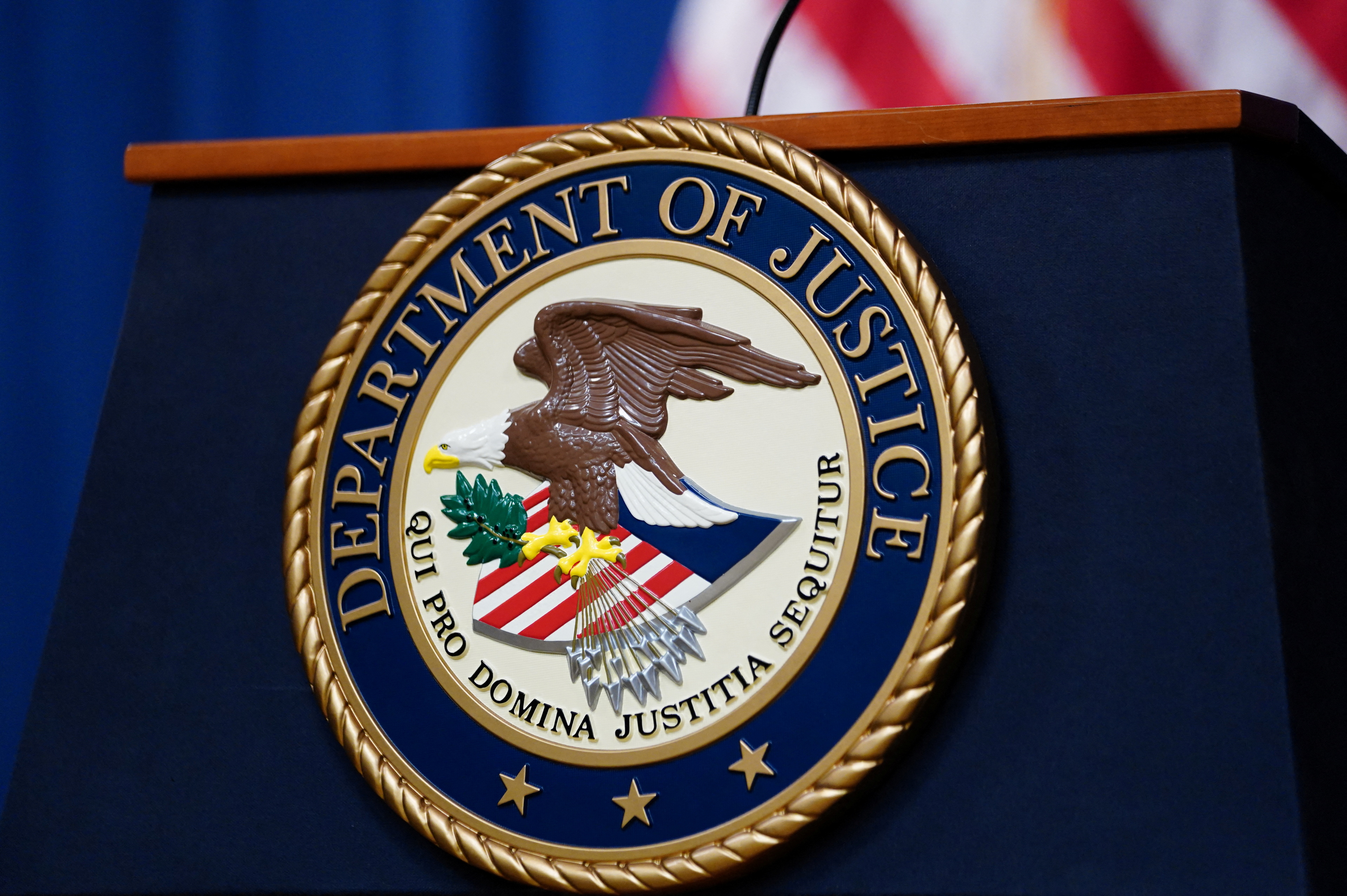 The seal of the U.S. Justice Department is seen on the podium in the Department's headquarters briefing room before a news conference with the Attorney General in Washington, January 24, 2023. 