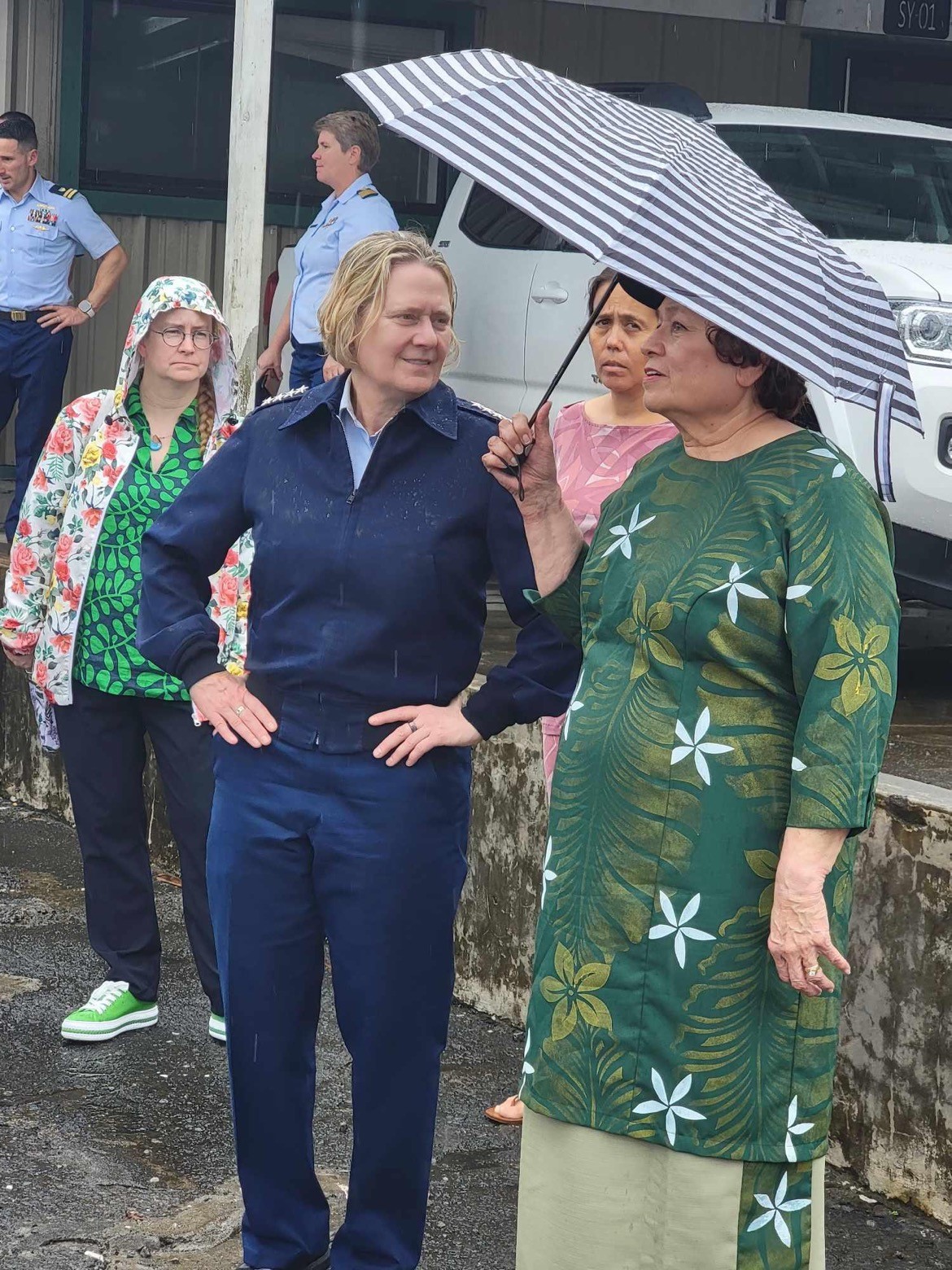 Congresswoman Amata and Admiral Fagan speaking on a rainy day in American Samoa.