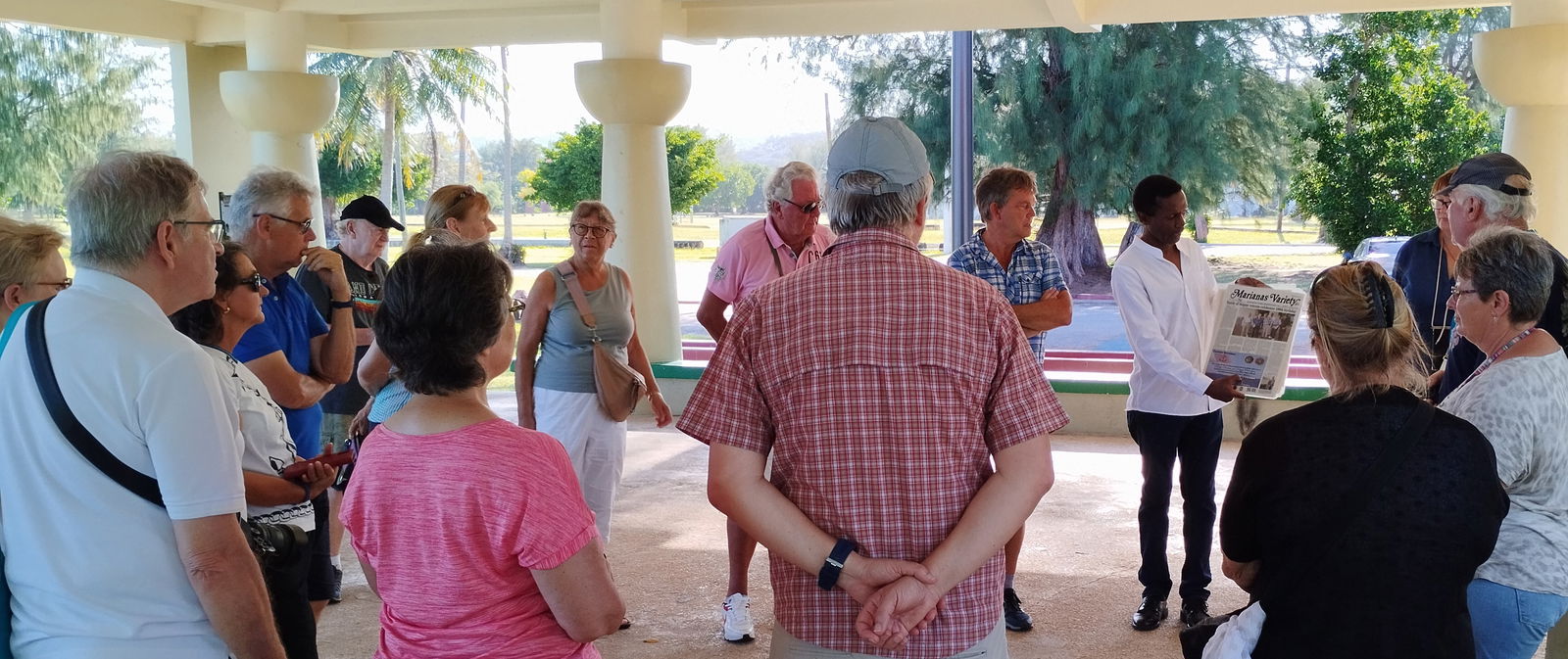 Local author Walt Goodridge provides a brief CNMI orientation at the Micro Beach pavilion while a guest translates.