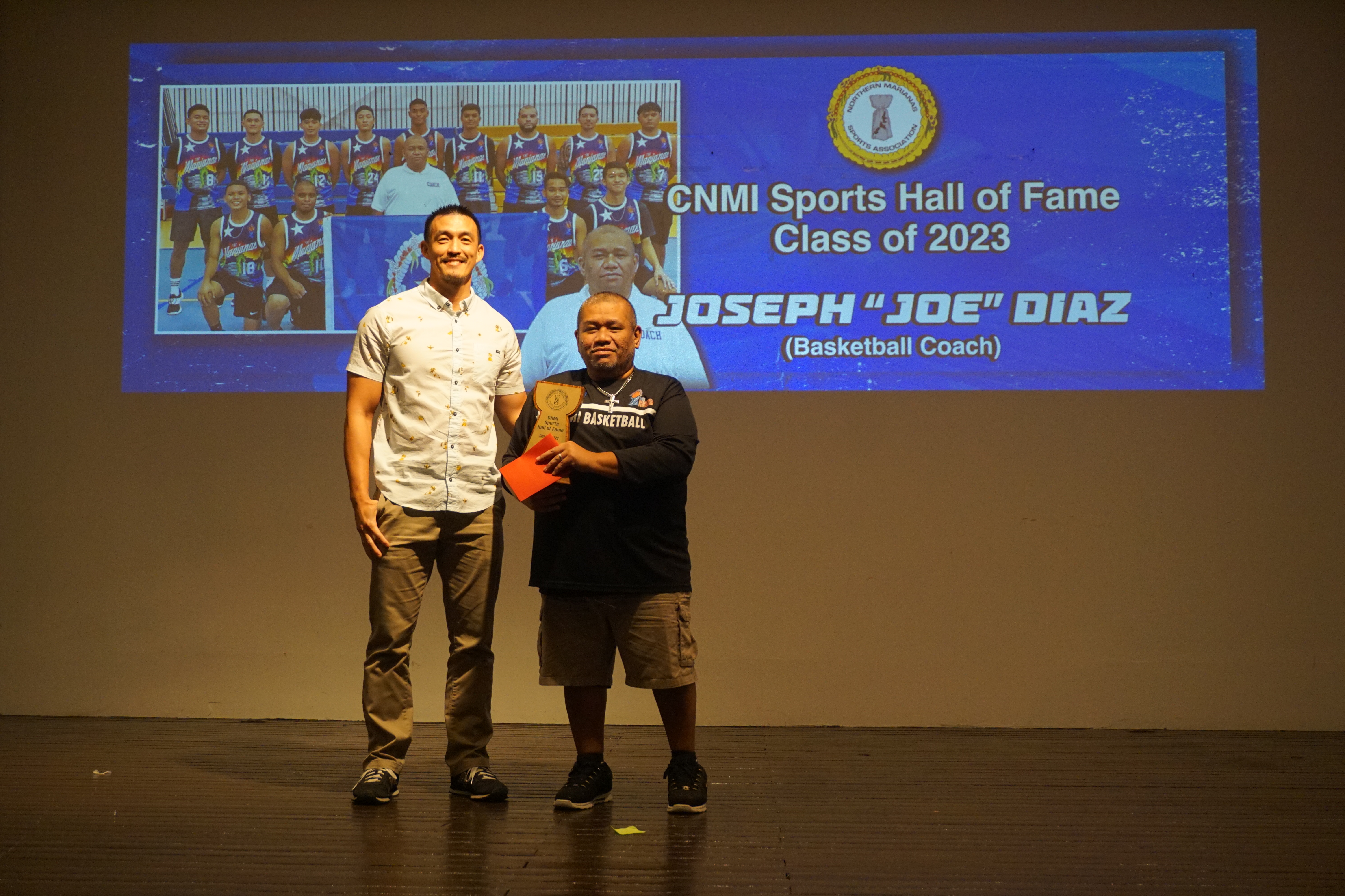 Joseph "Joe" Diaz holds the CNMI Sports Hall of Fame trophy as he poses for a photo with Northern Mariana Islands Basketball Federation President James Lee during the Northern Marianas Sports Association Annual Awards Banquet at the Hibiscus Hall of the Crowne Plaza Resort Saipan on Wednesday evening.