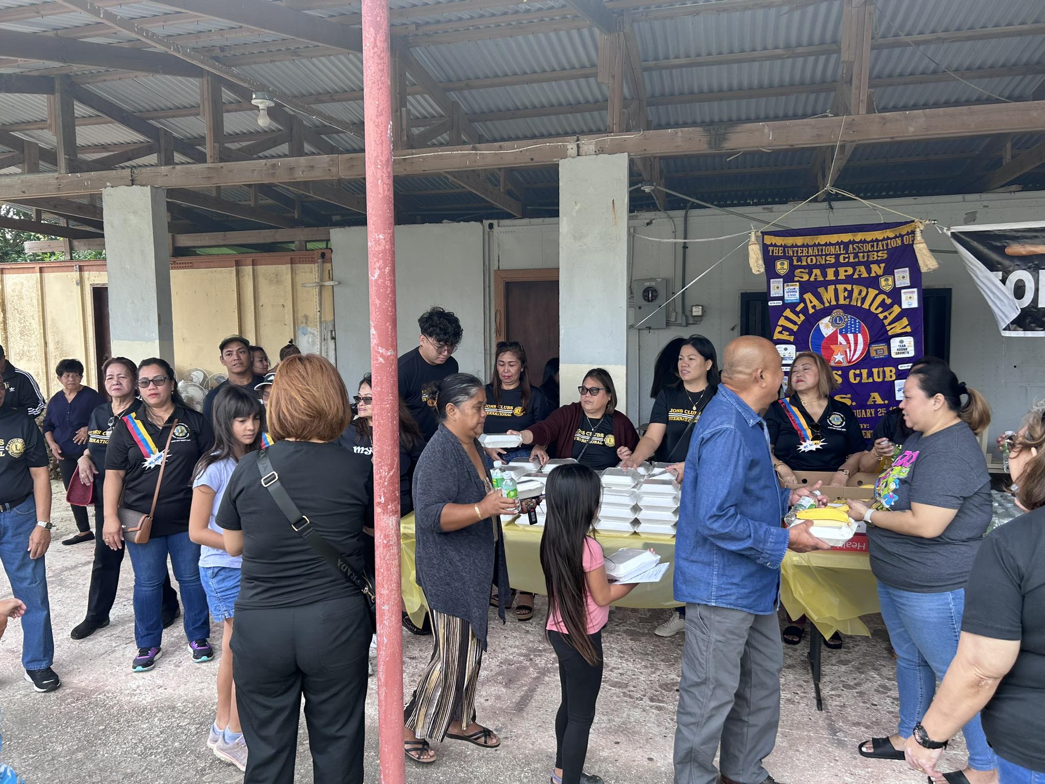 Tanapag residents get their free meals from Fork & Spoon House of Sizzling.